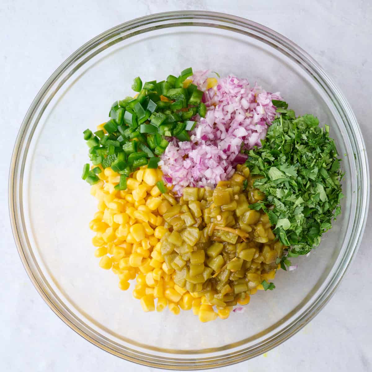 Corn salsa ingredients in a bowl before mixing.