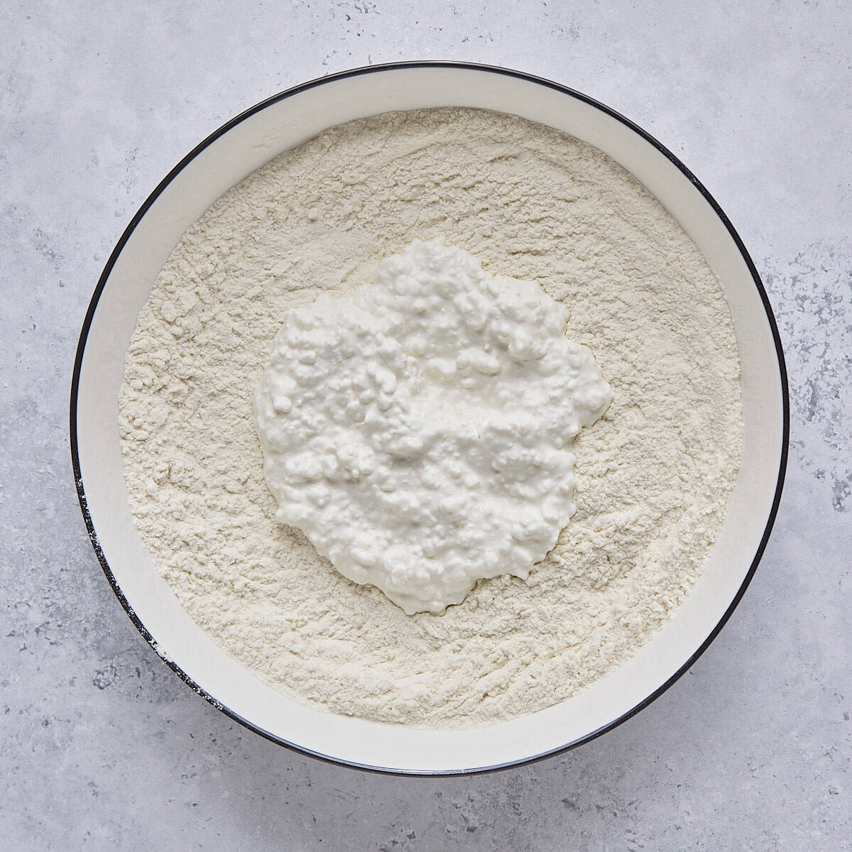 Dry ingredients and cottage cheese in a large bowl.