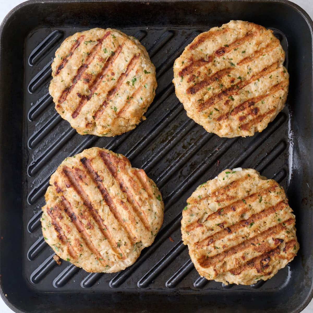 After flipping patties to show grill marks.
