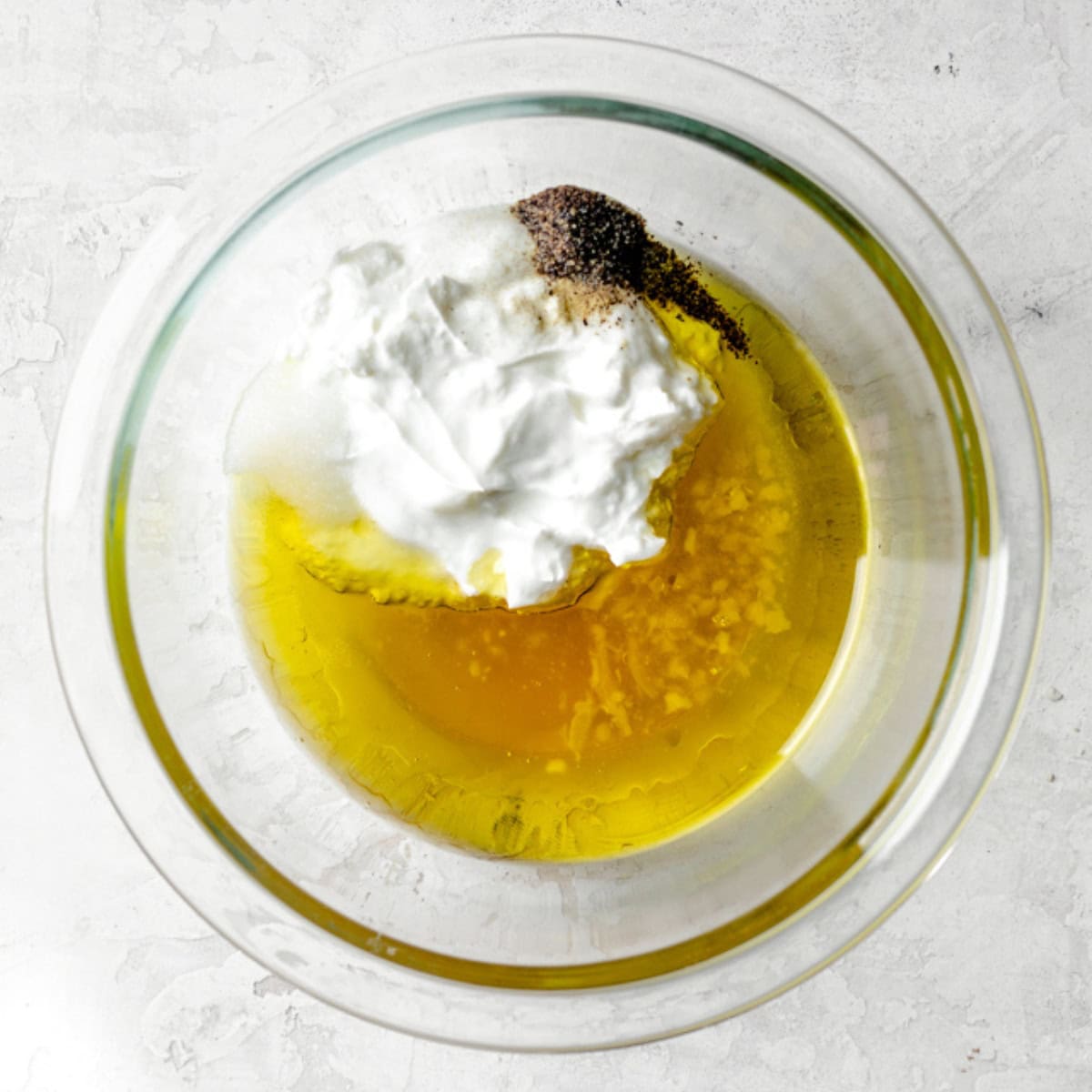 Dressing ingredients in a small bowl before mixing.