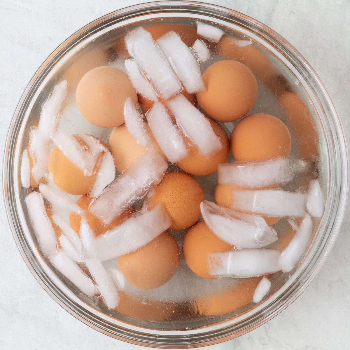 Boiled eggs in a bowl of ice water.
