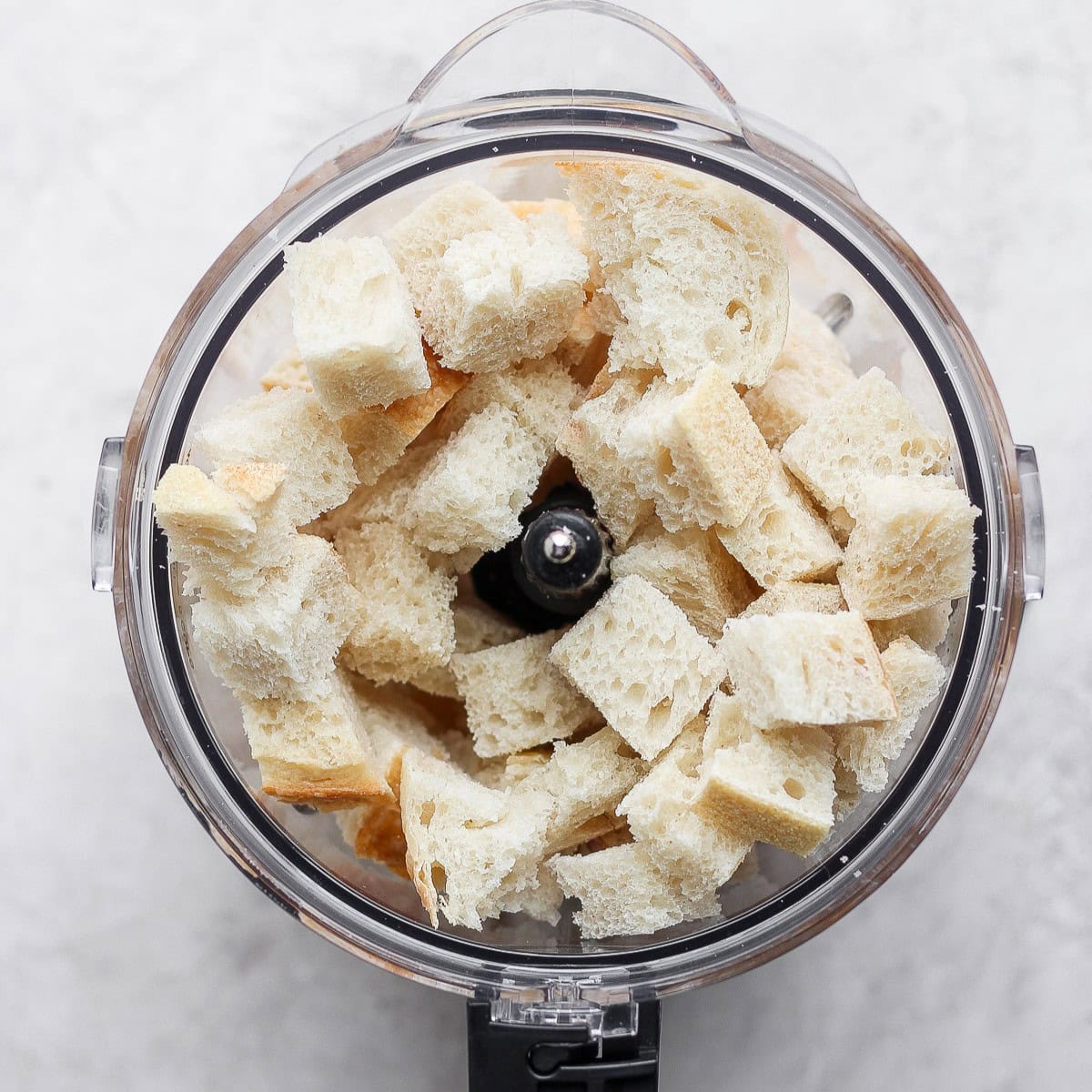Toasted bread cubes in a food processor.
