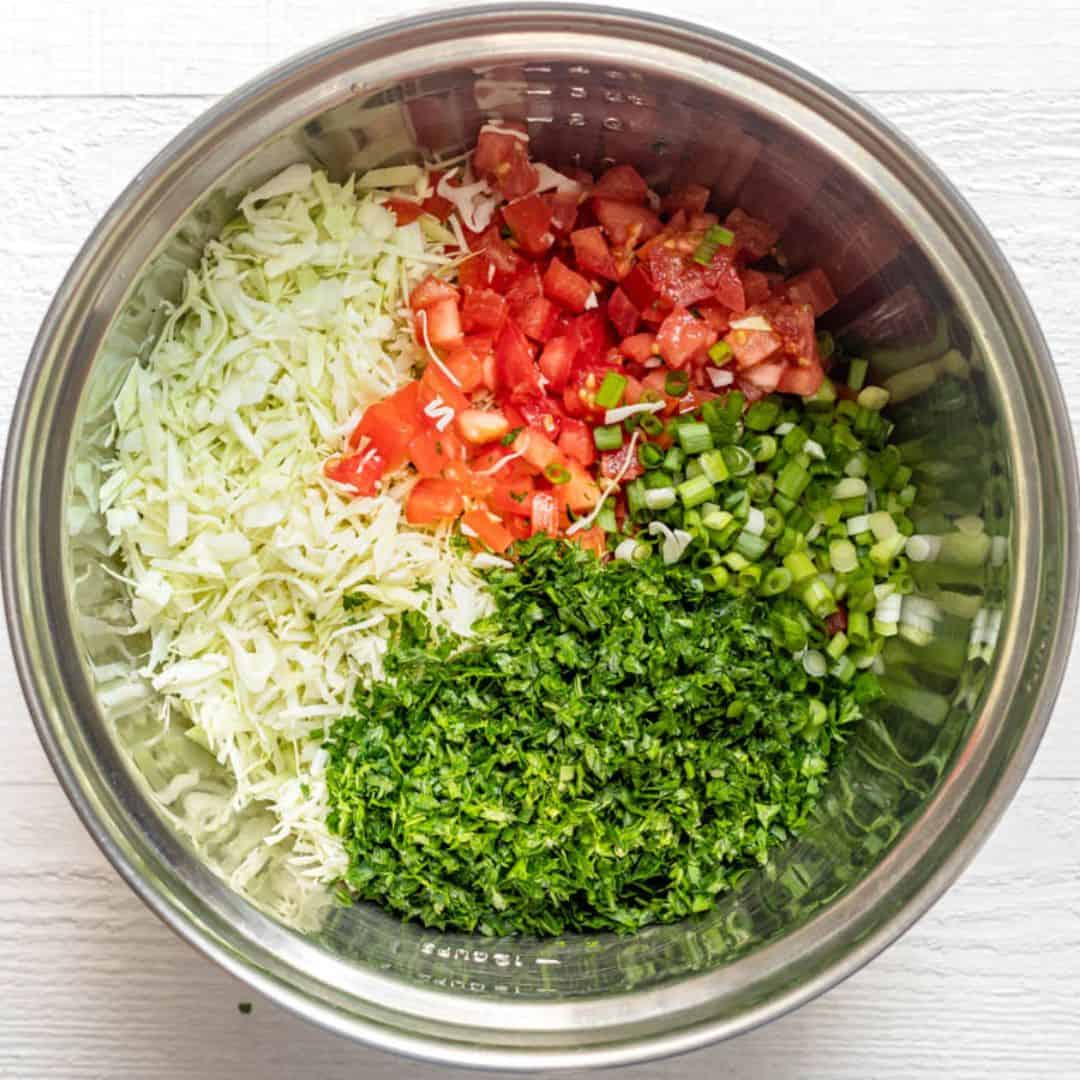 Recipe ingredients in a large mixing bowl before tossing together.