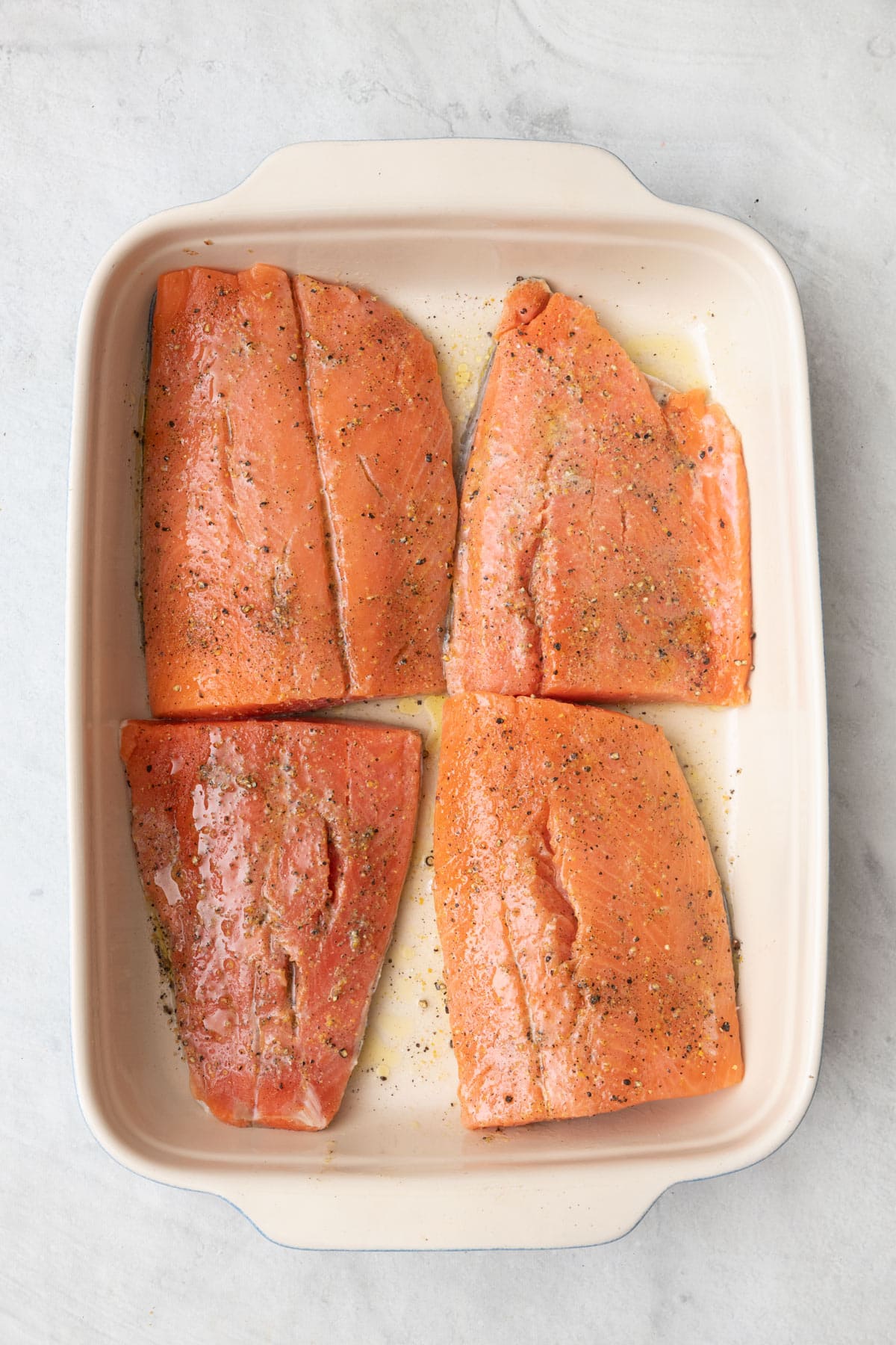 Salmon skin side down in baking dish before baked.