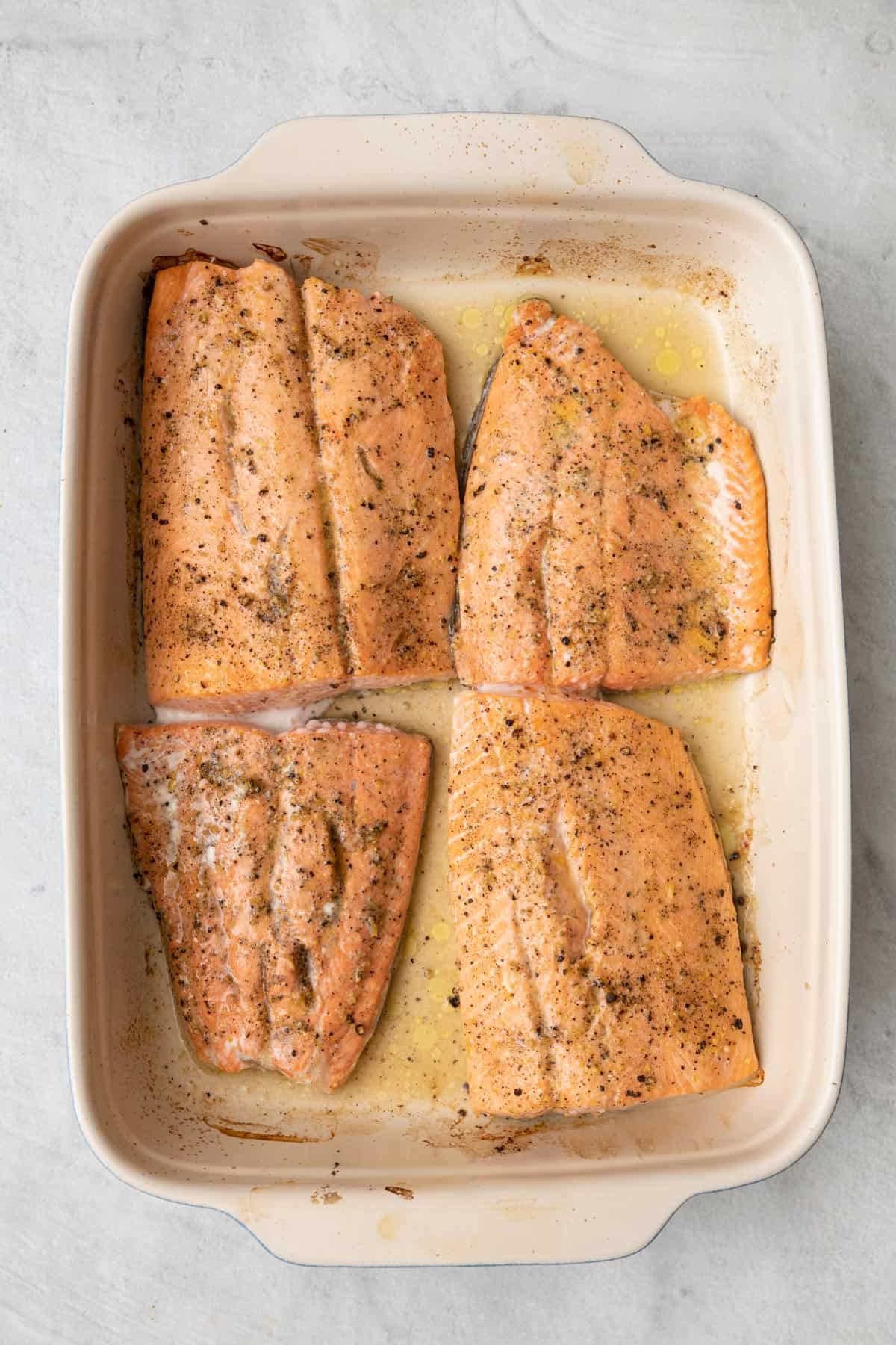 Salmon after baked still in baking dish.
