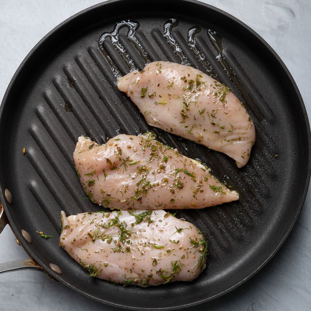 Chicken on grill pan before cooking.