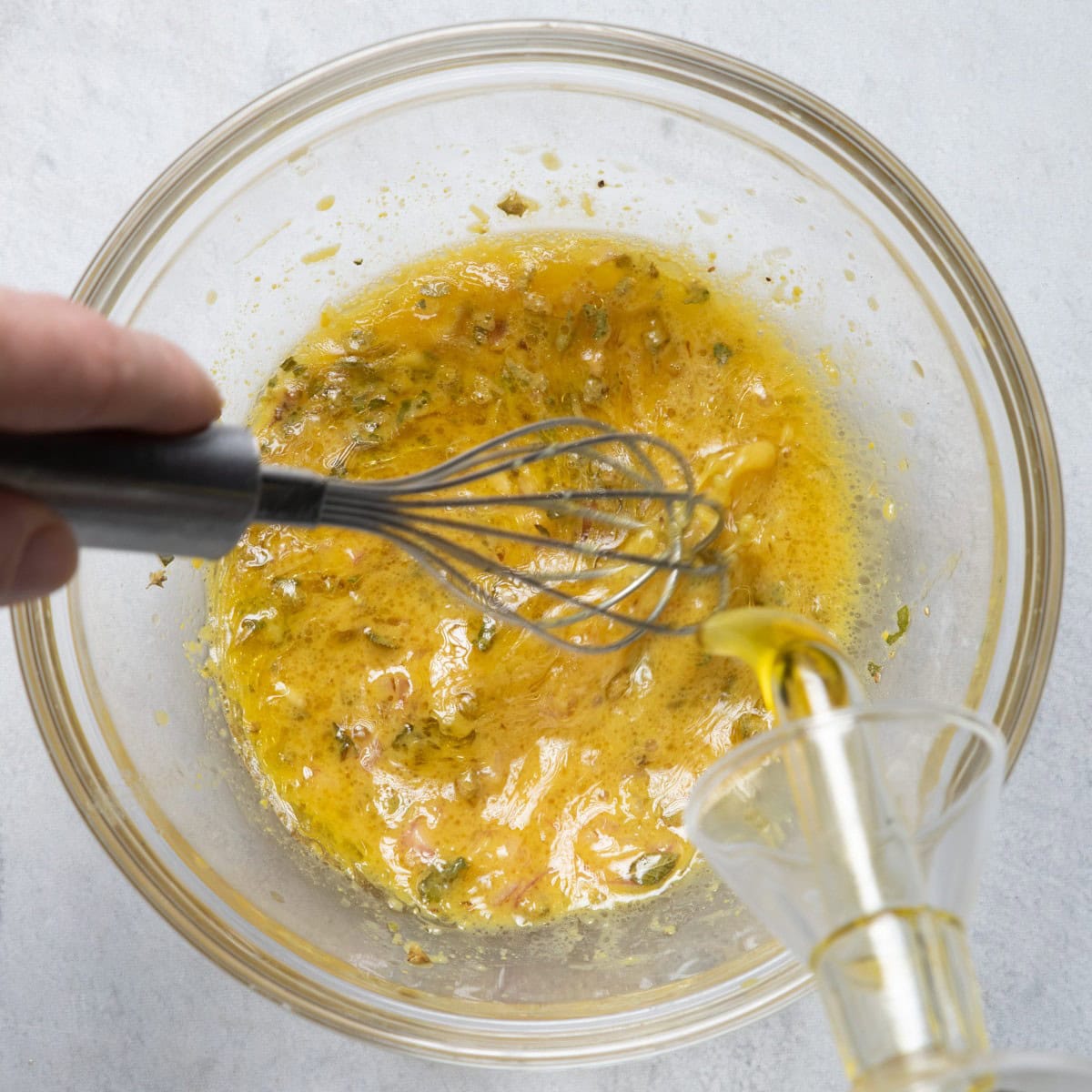 Hand whisking dressing.