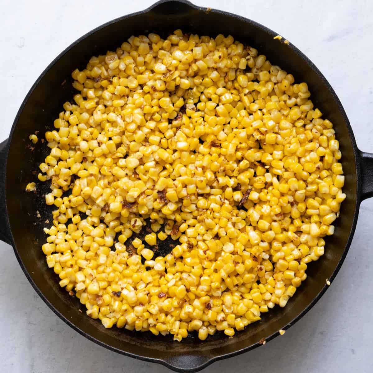 Charred corn on the skillet.