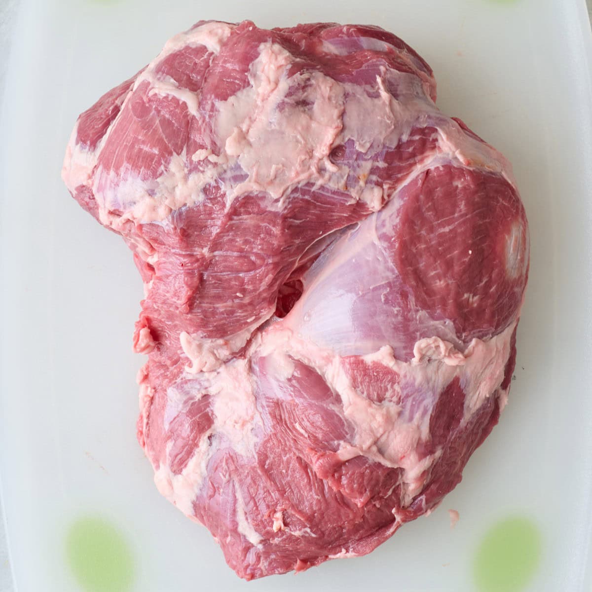 Leg of lamb on a cutting board.