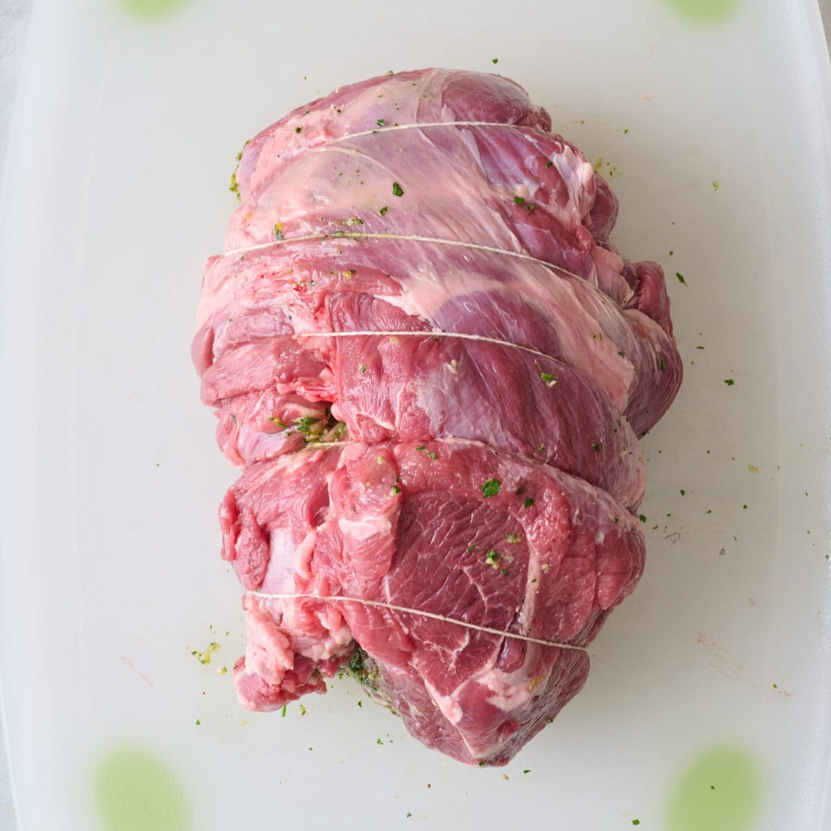 Twine wrapped around leg of lamb.