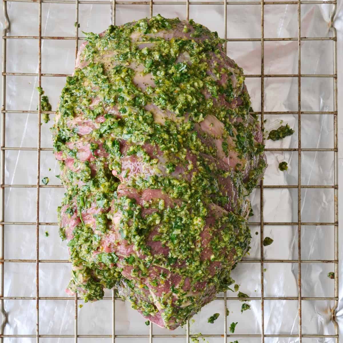 Lamb transferred to a wire rack over a foil lined pan and coated with remaining herb seasoning.