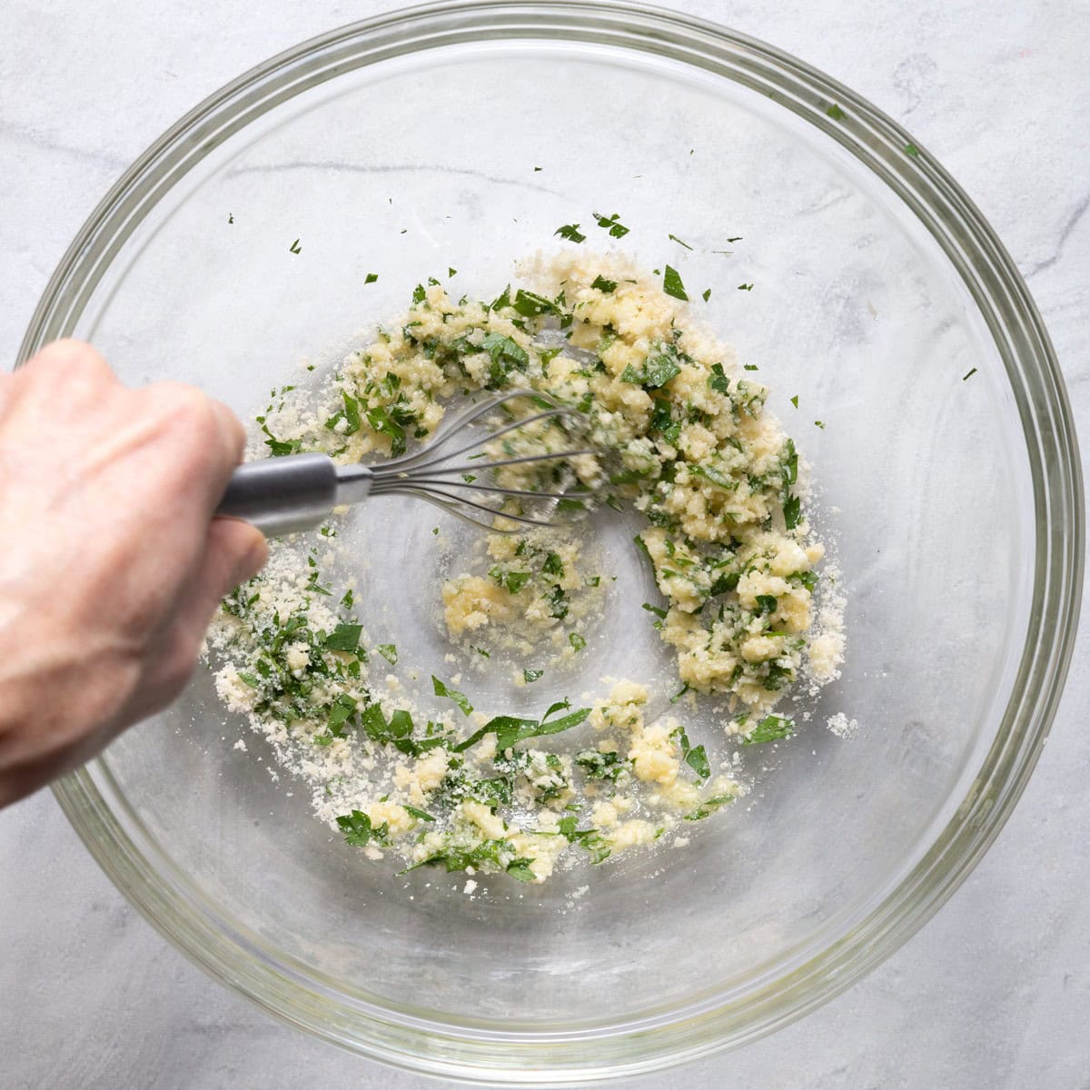 Garlic lemon spread being mixed in a bowl.