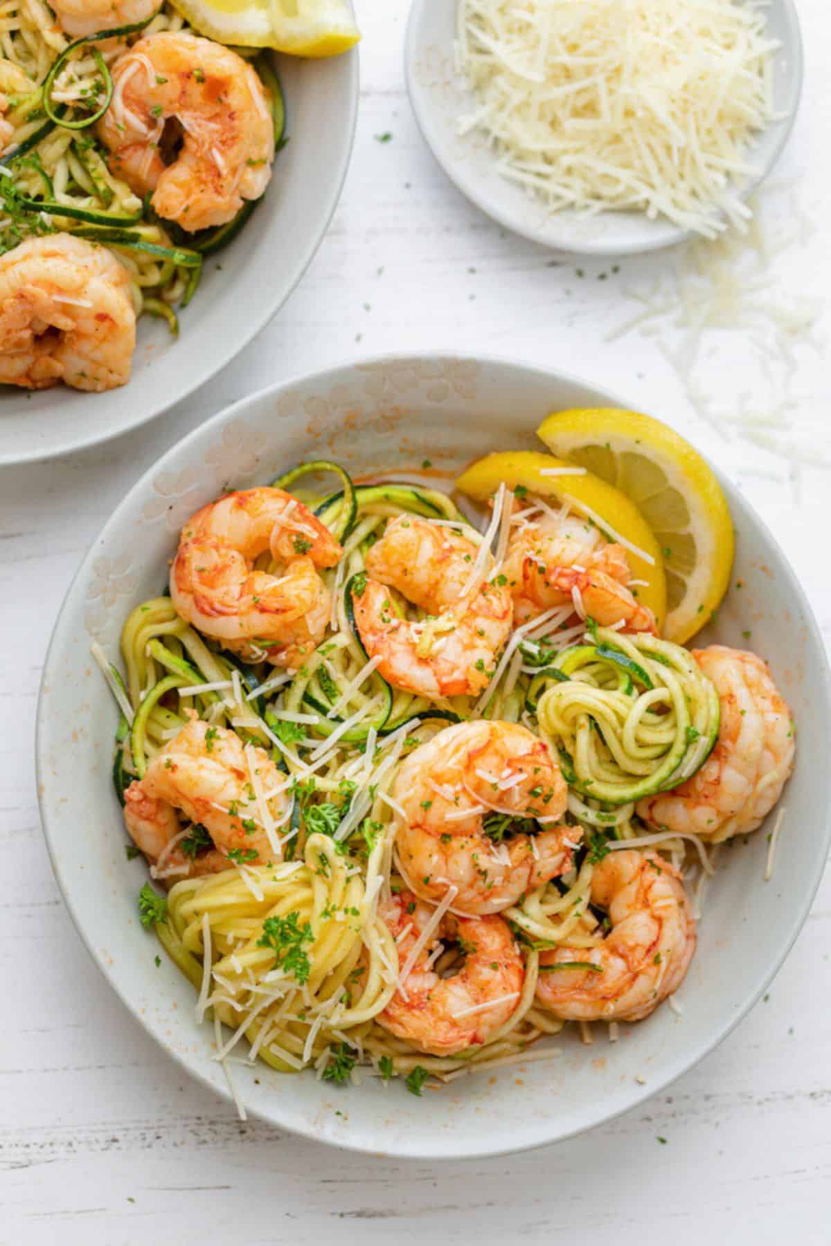 Two servings of shrimp scampi zoodles with parmesan.