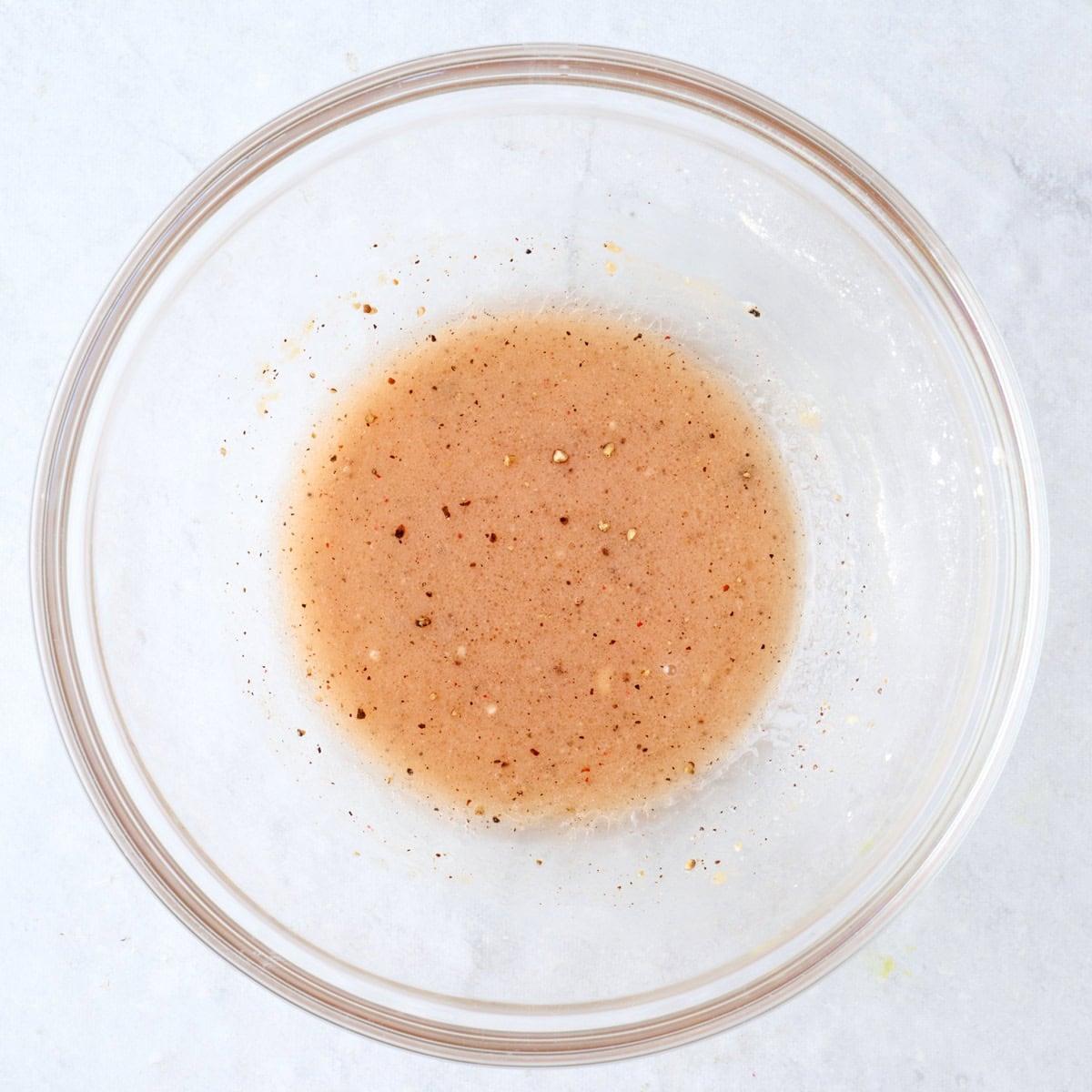Oil and seasonings in a bowl.