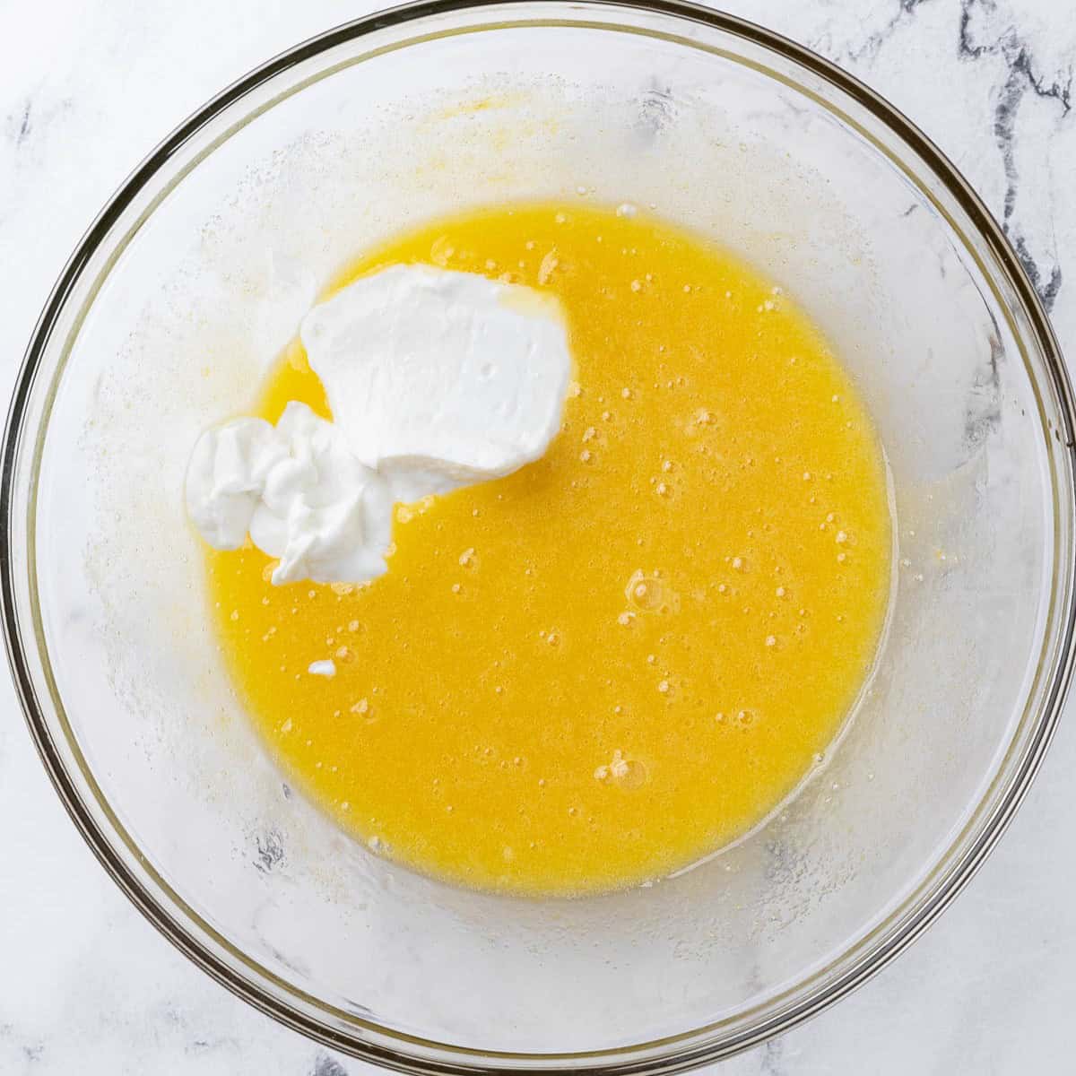 After whisking eggs with greek yogurt added before mixing.