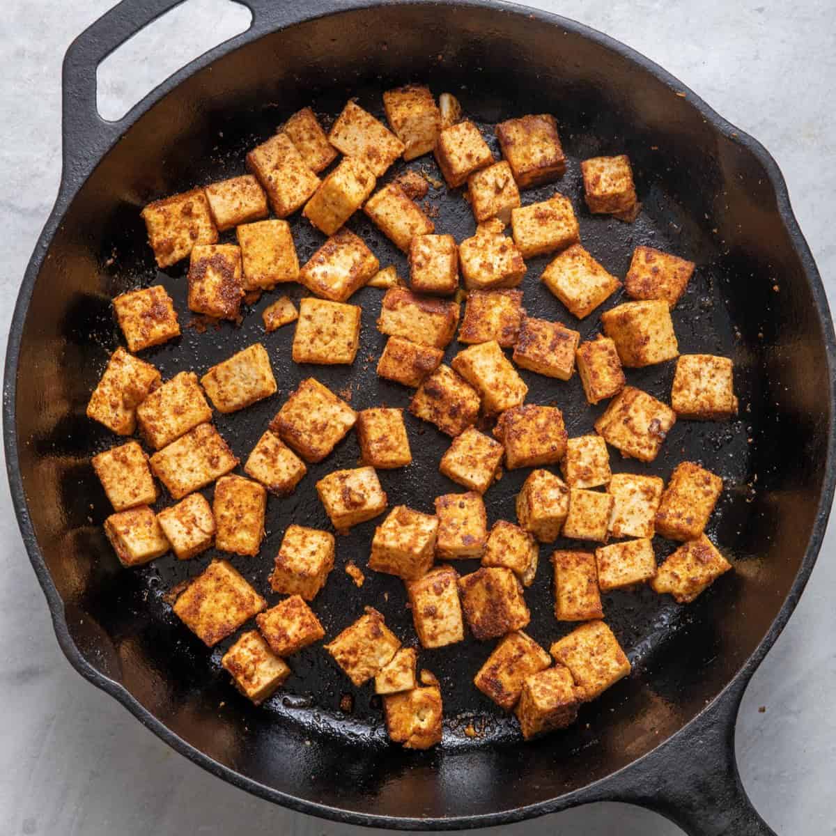 Tofu cooked on skillet - show some charring so it looks crisp.