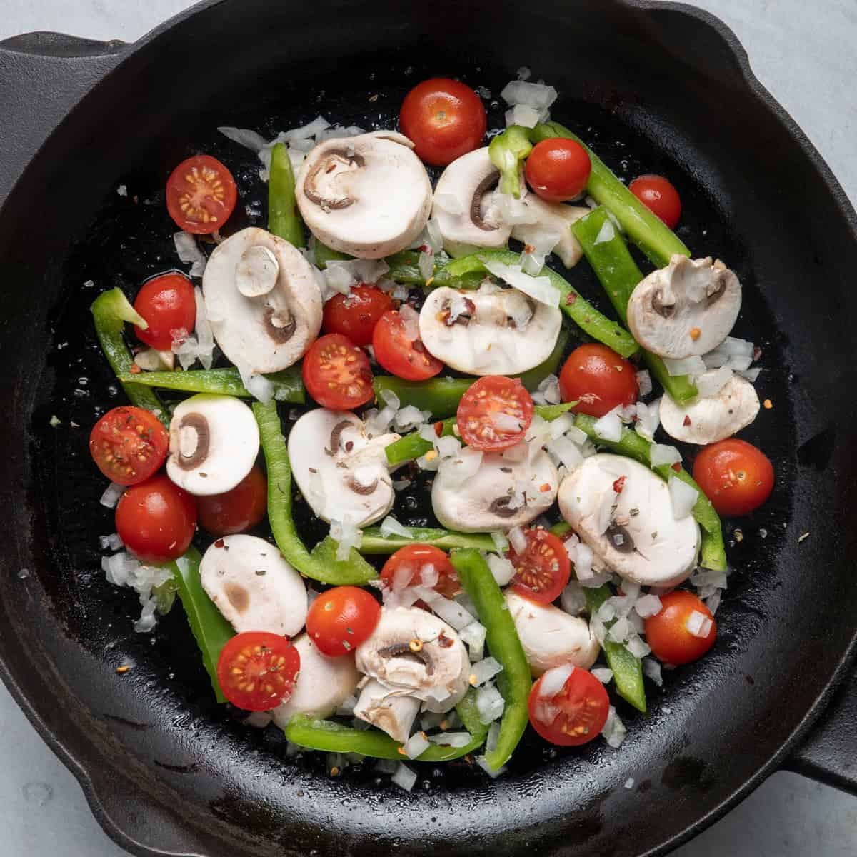 Add peppers, tomatoes, onions, and seasoning.