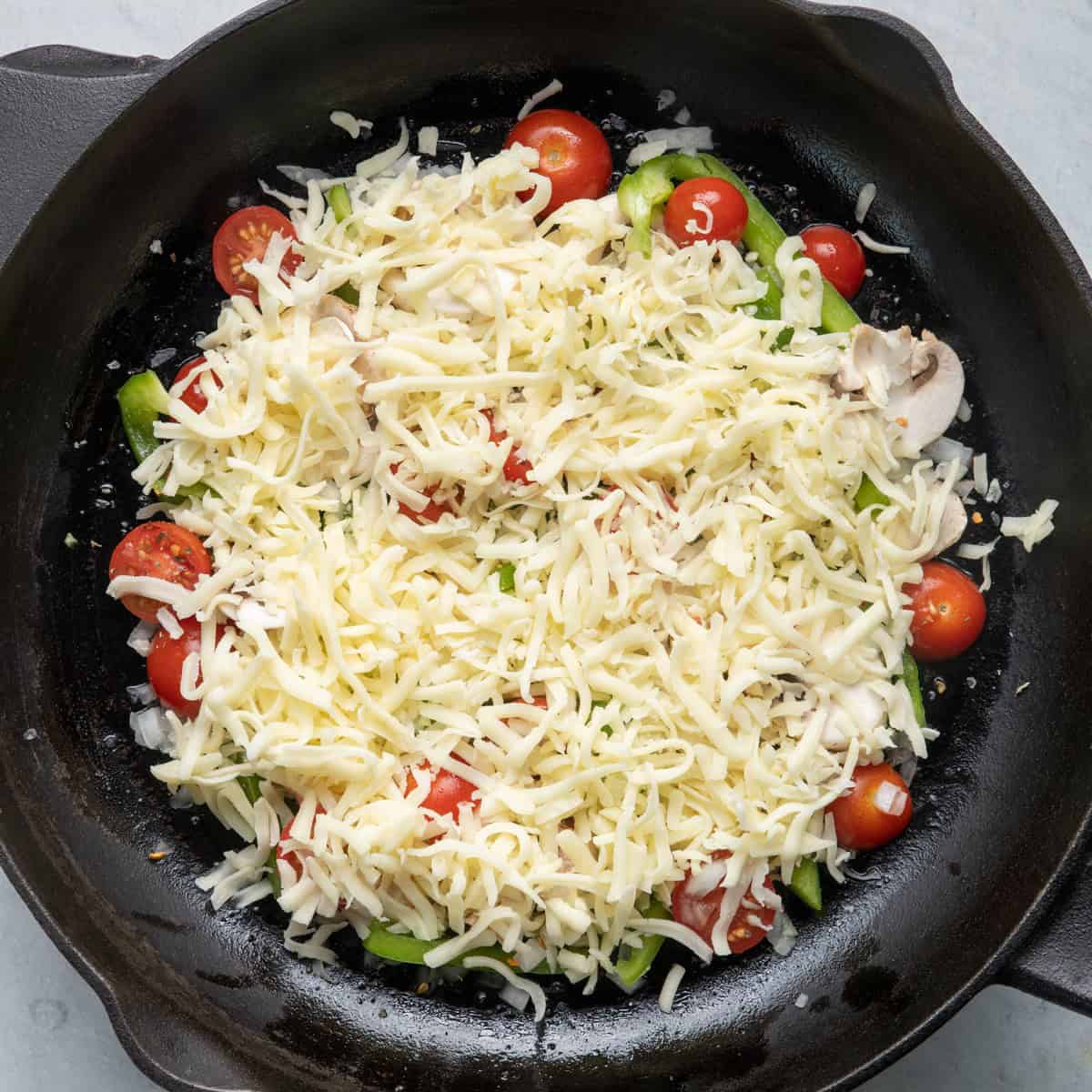 Cheese added on top of veggies.