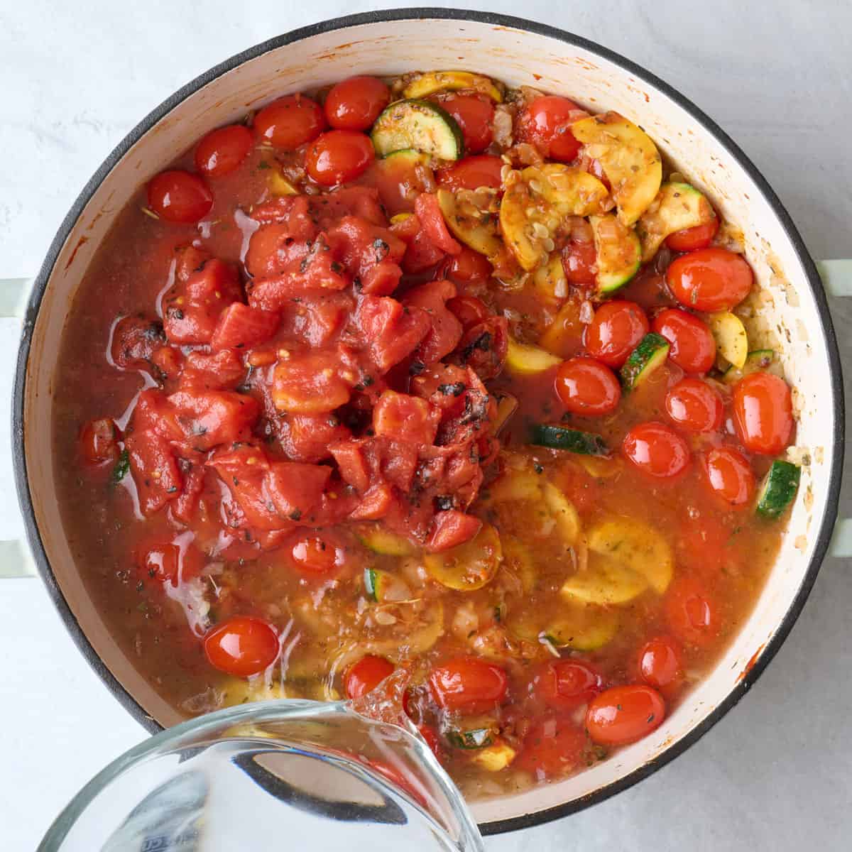 Canned tomatoes and broth added.
