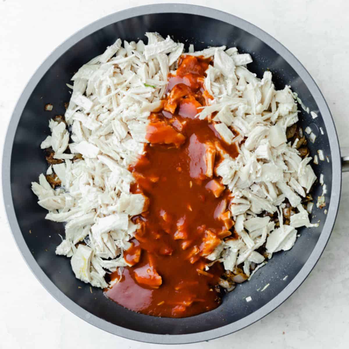 Shredded chicken and sauce added on top.