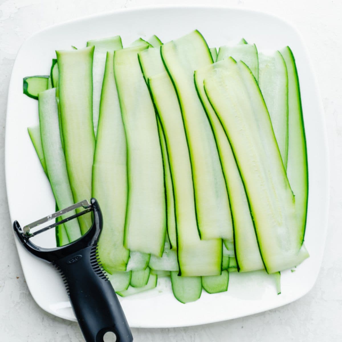 Zucchini cut with a y-peeler into thin planks.