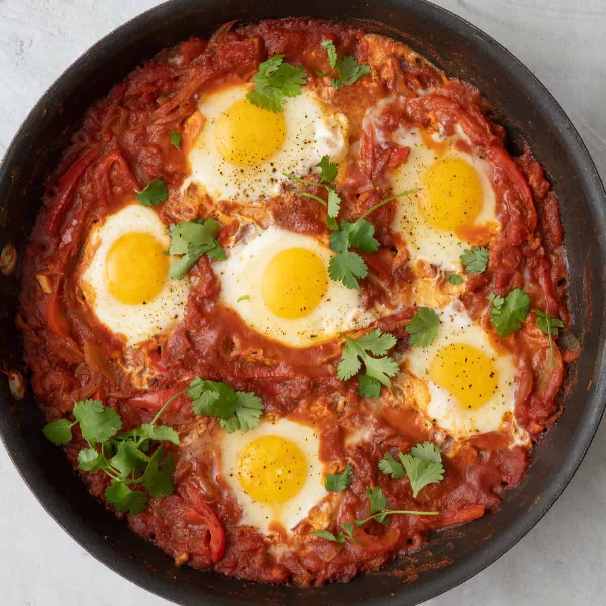 Eggs after cooked in stew garnished with fresh cilantro.