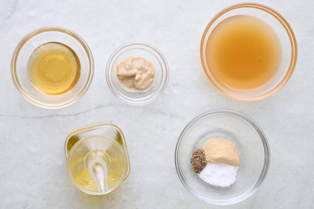 Ingredients for recipe: apple cider, honey, Dijon mustard, garlic powder, salt, black pepper and oil.