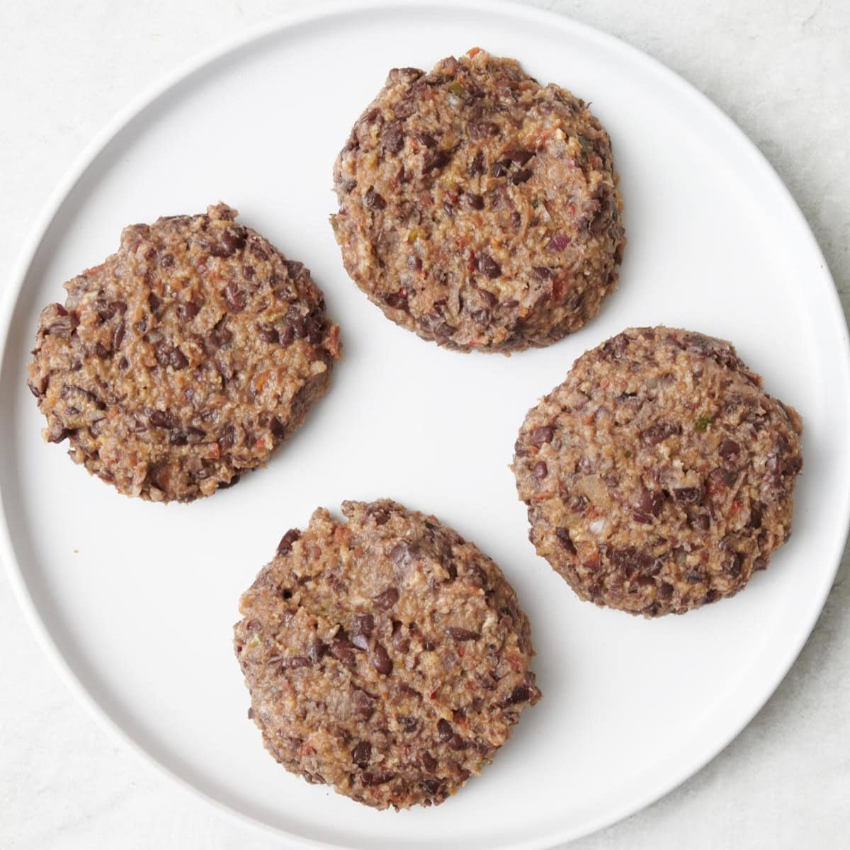 Bean patties on a plate after forming.