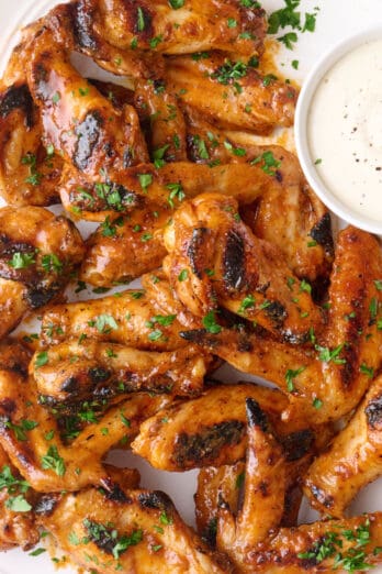 Grilled chicken wings recipe tossed in buffalo sauce.