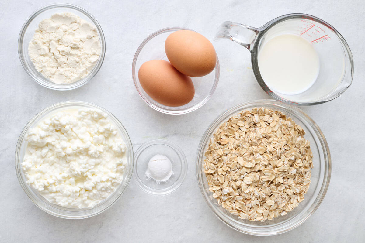 Ingredients for recipe: flour, cottage cheese, oats, baking powder, eggs, and milk.