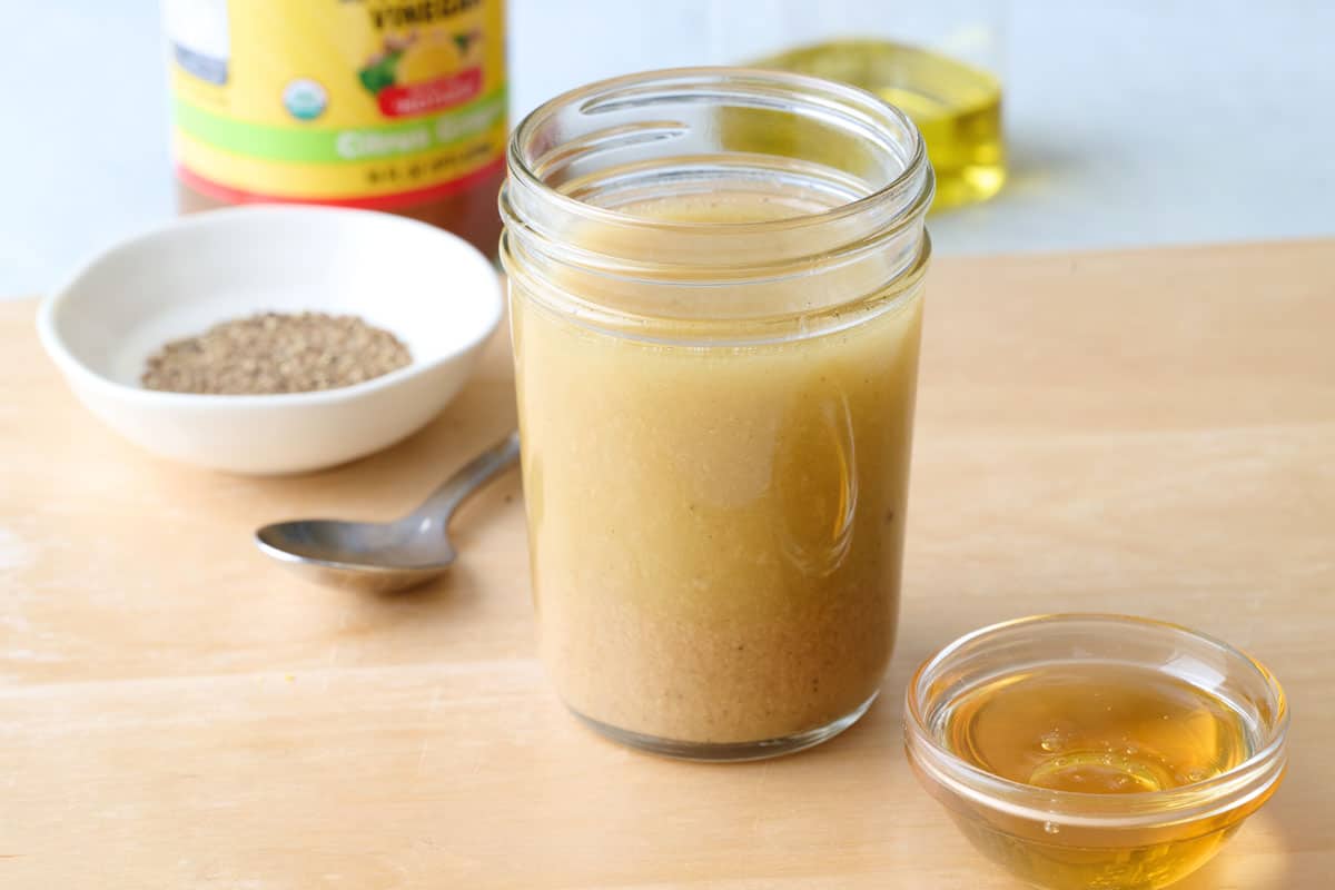 Zesty apple cider vinaigrette in a small mason jar.