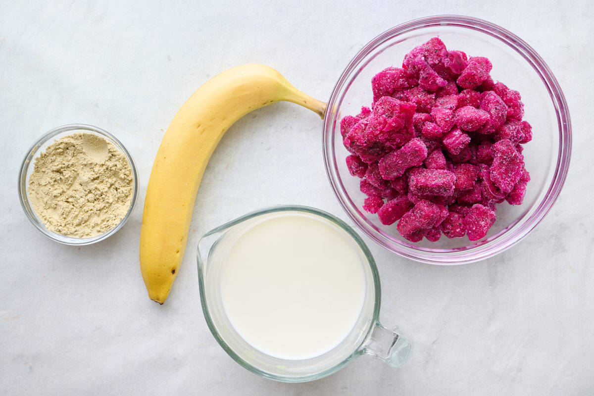 Ingredients for recipe: vanilla protein powder, frozen banana, frozen dragon fruit cubes, and milk.