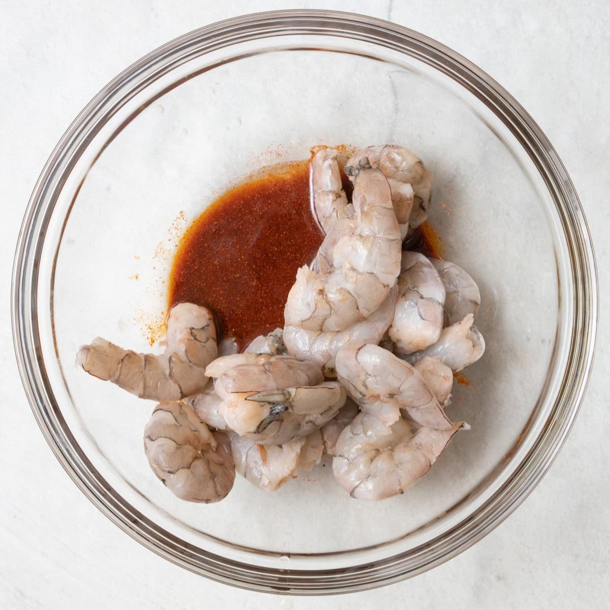 Shrimp in a bowl of marinade.