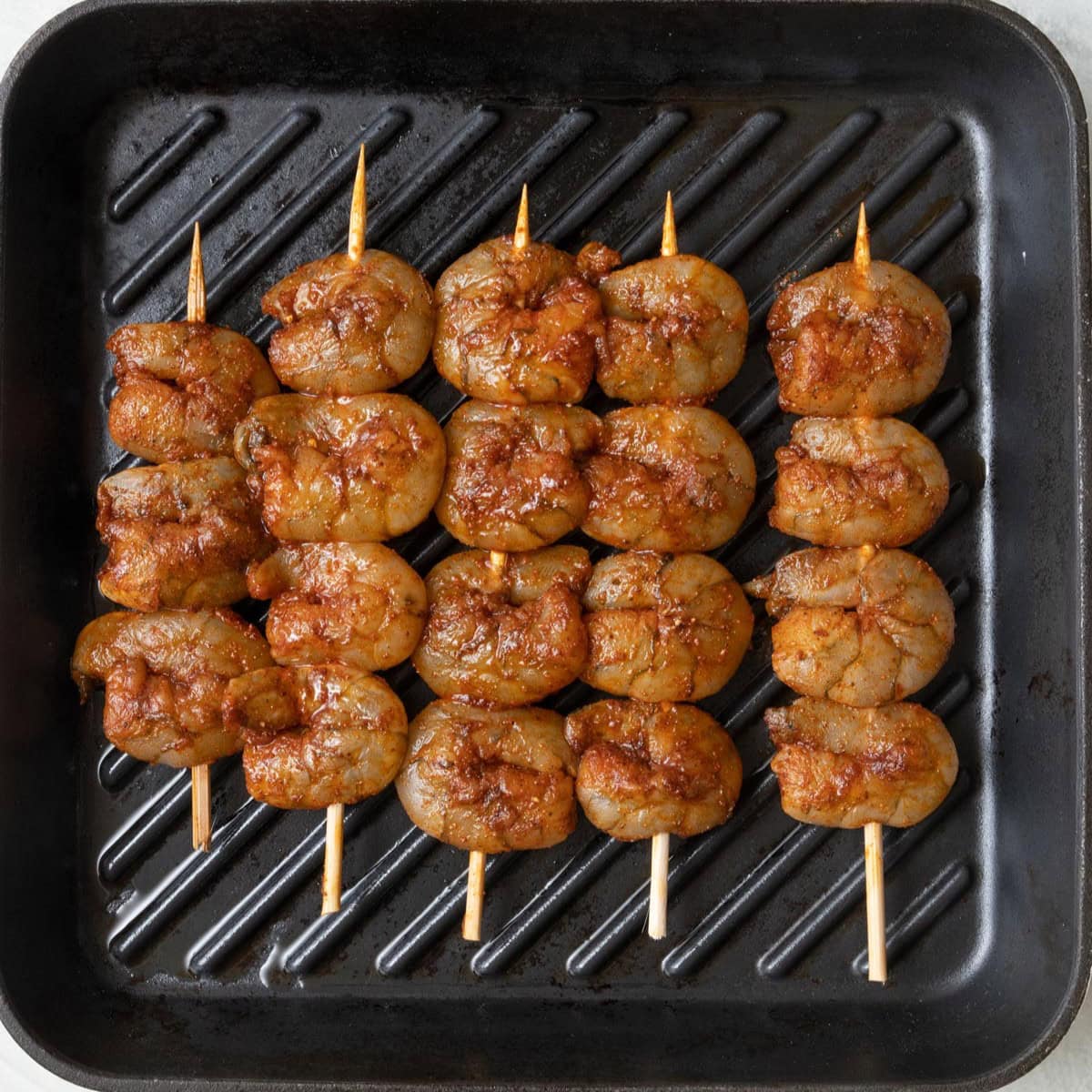 Shrimp skewers on a grill pan.