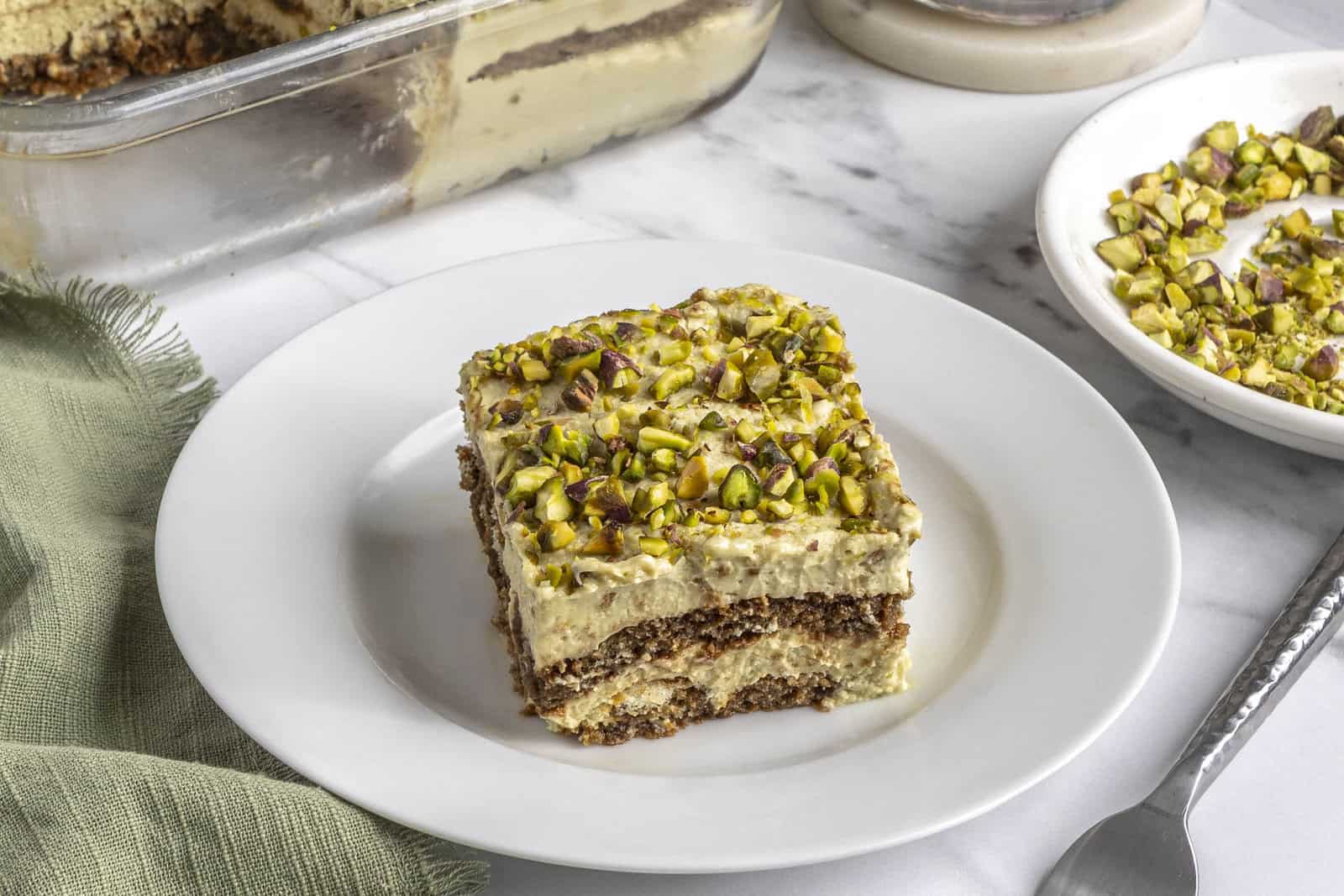 Slice of homemade pistachio tiramisu on a plate.