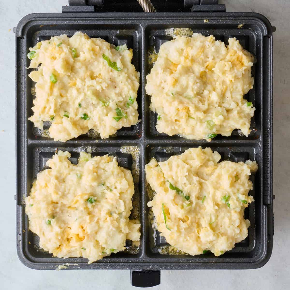 After adding waffle batter, before cooking.