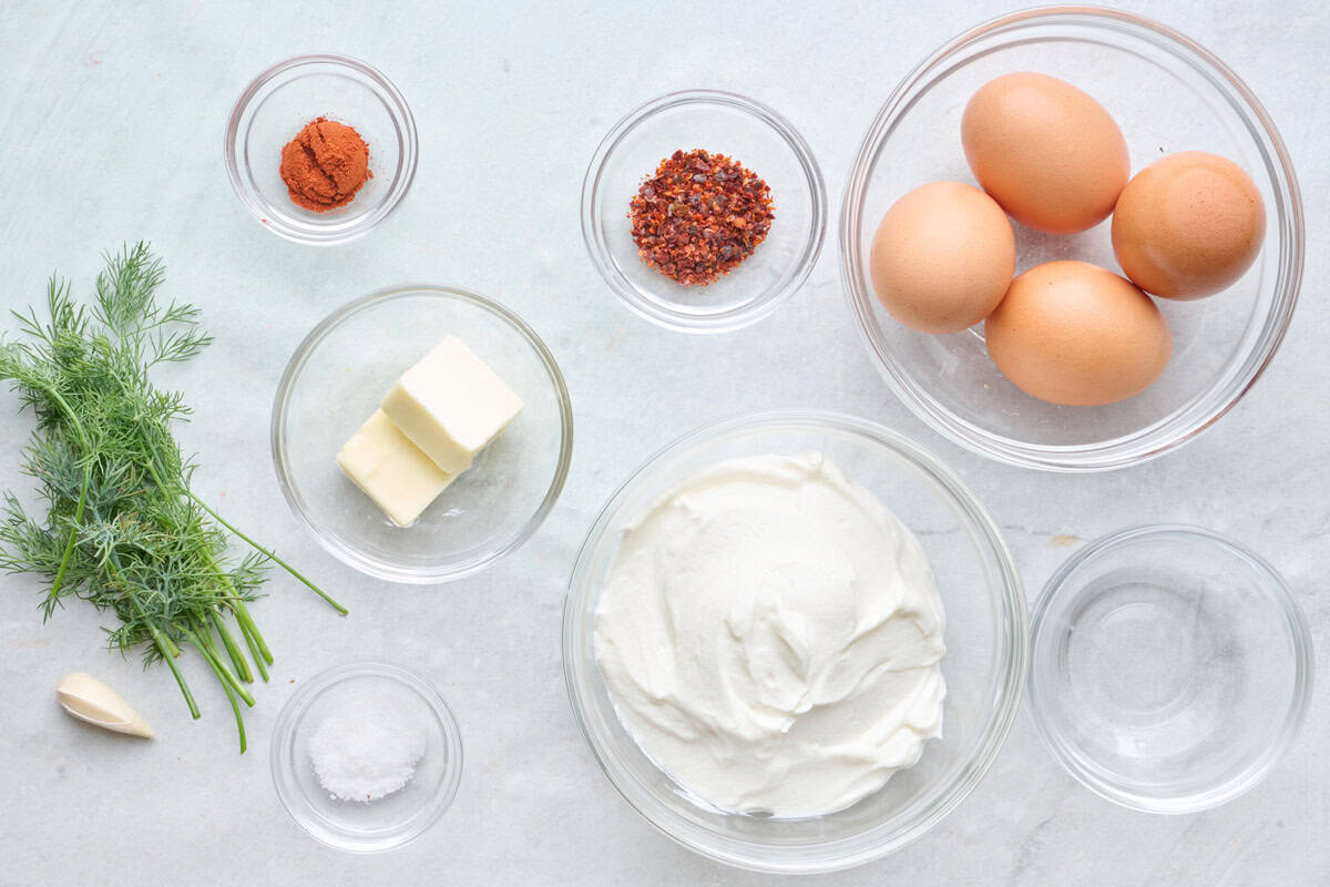 Ingredients for recipe: fresh dill, garlic, aleppo pepper, paprika, vinegar, eggs, butter, salt, and yogurt.