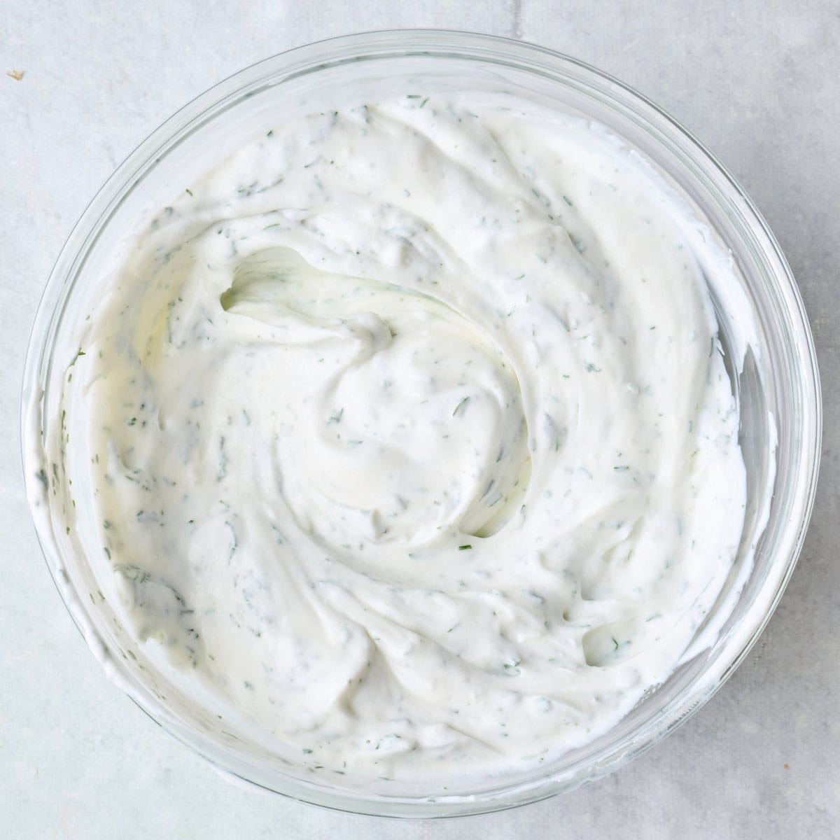 Yogurt dill mixture in a bowl.