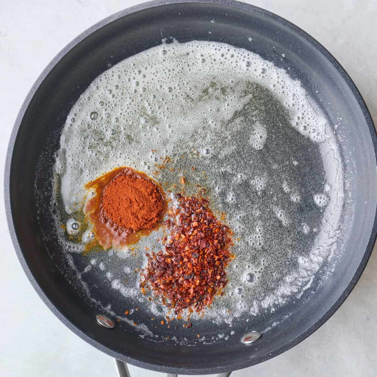 Foaming butter in small skillet with pepper and paprika added.