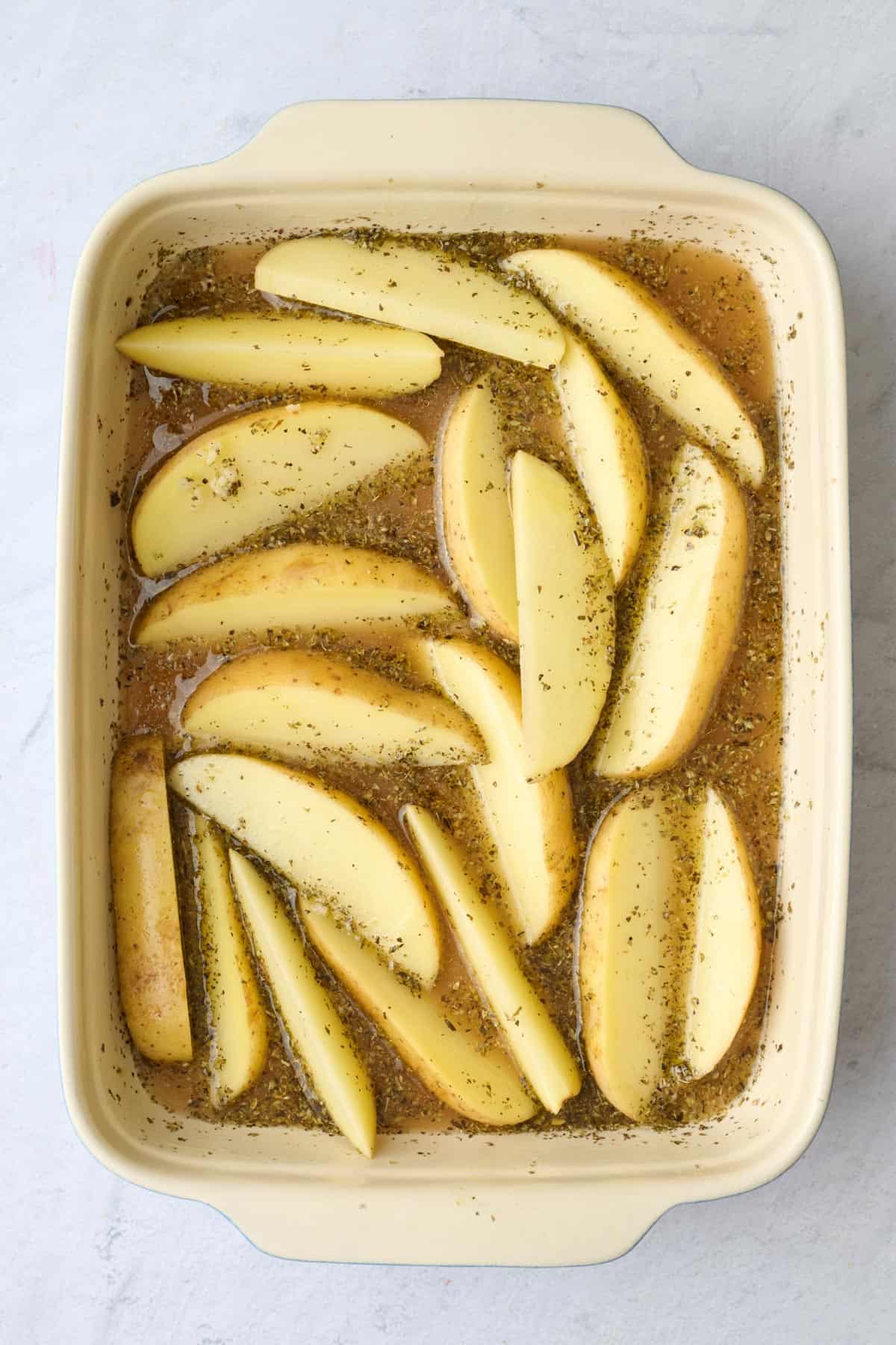 After potatoes are added and tossed in sauce.
