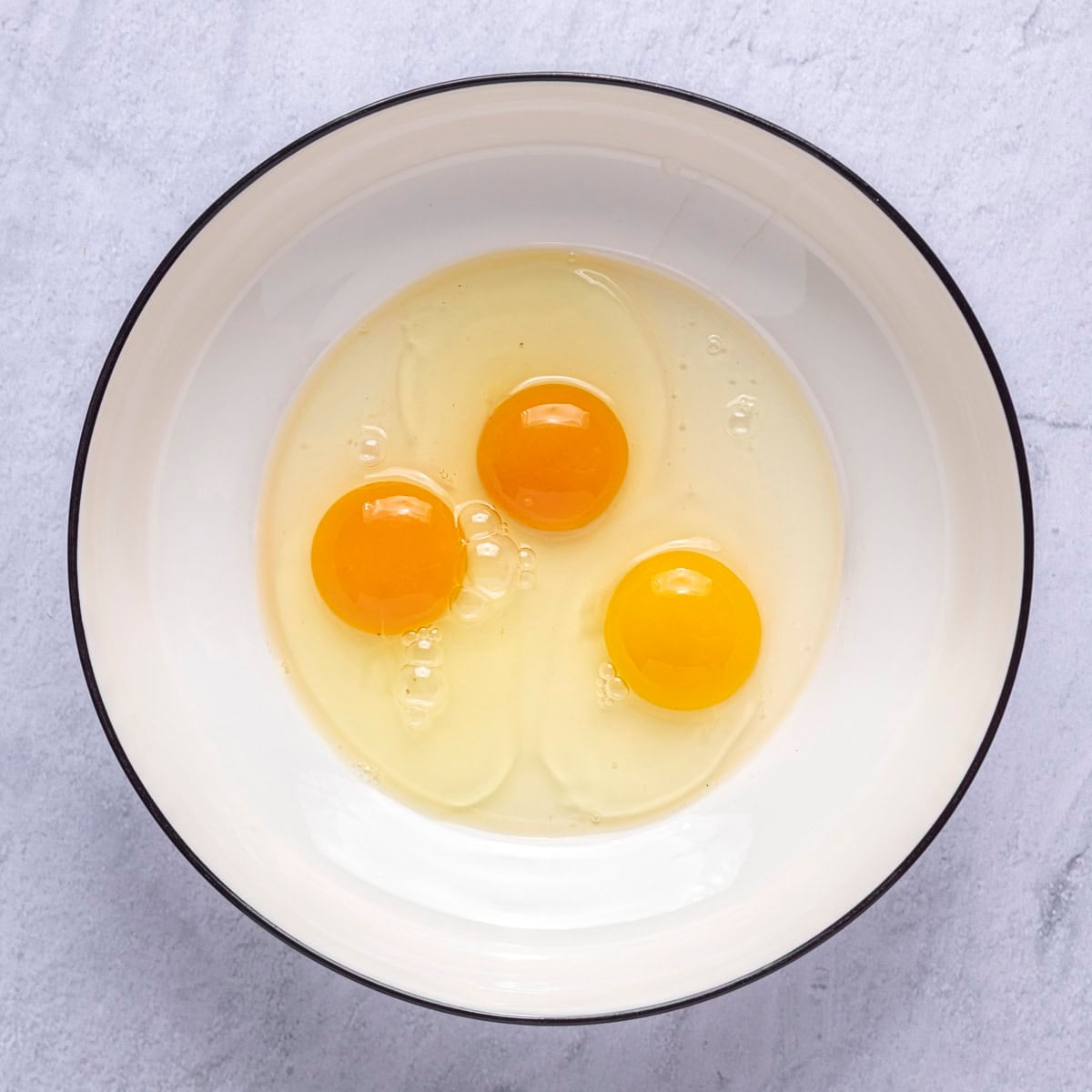 Eggs in a large bowl.