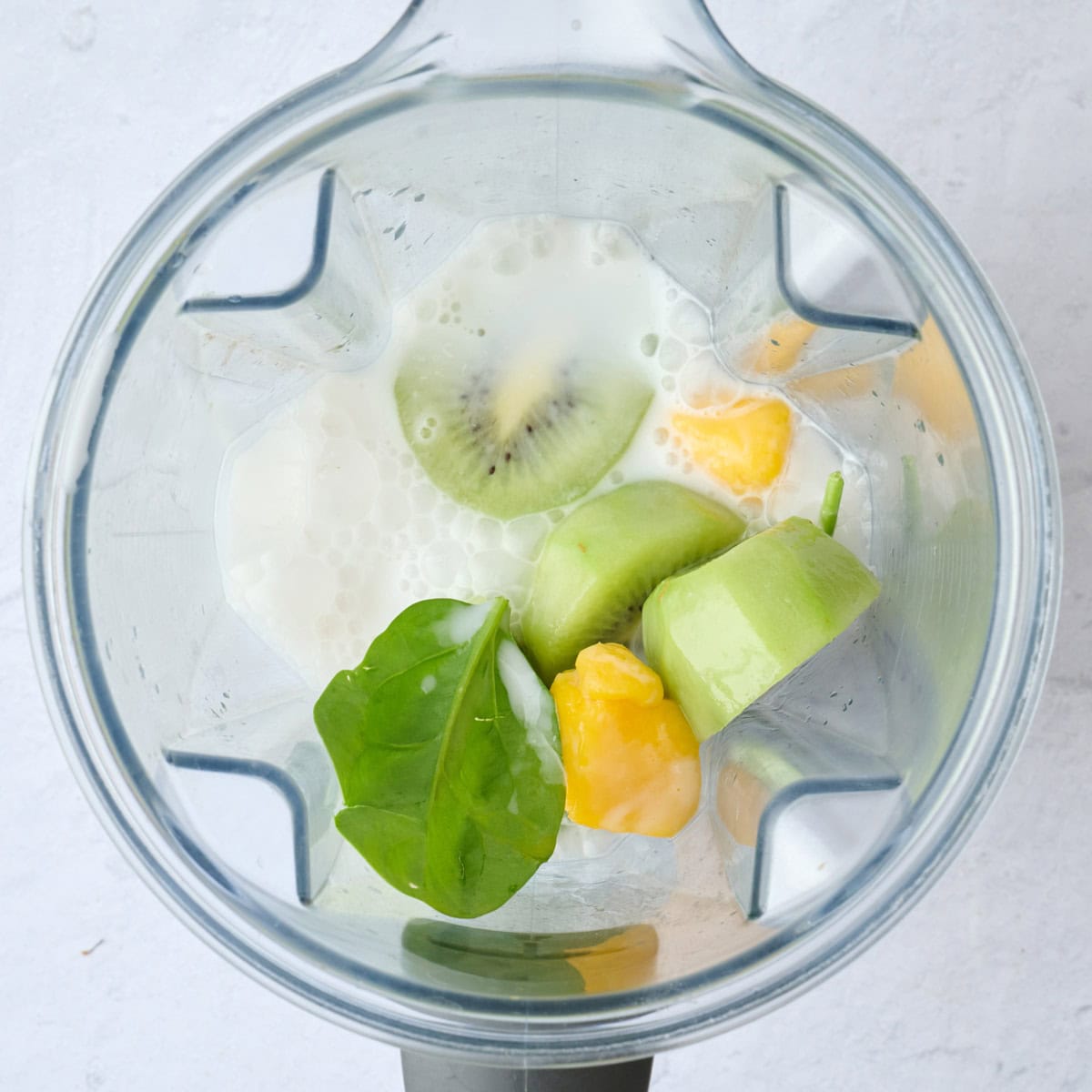 Smoothie ingredients in a blender before blending.