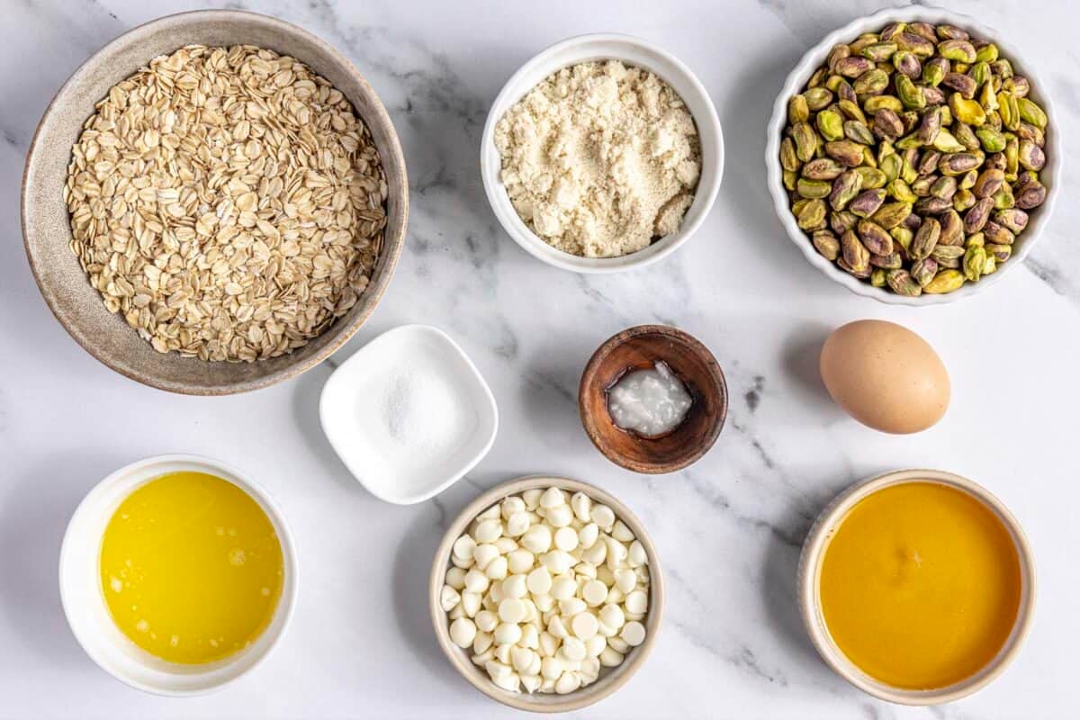 Ingredients for recipe: oats, almond flour, pistachios, salt, melted butter, egg, honey, and coconut oil.
