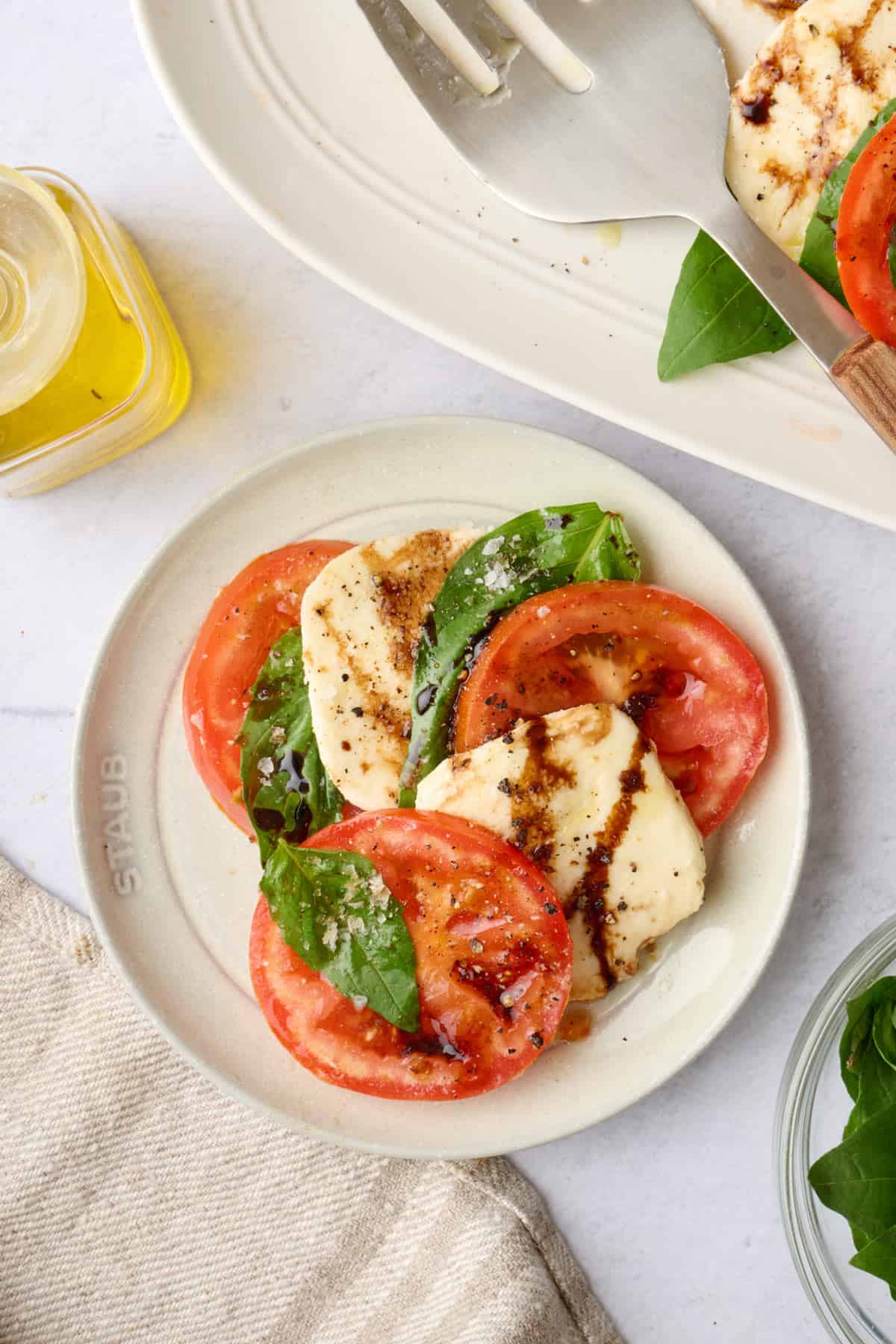 Assembled caprese salad on a small appetizer plate.
