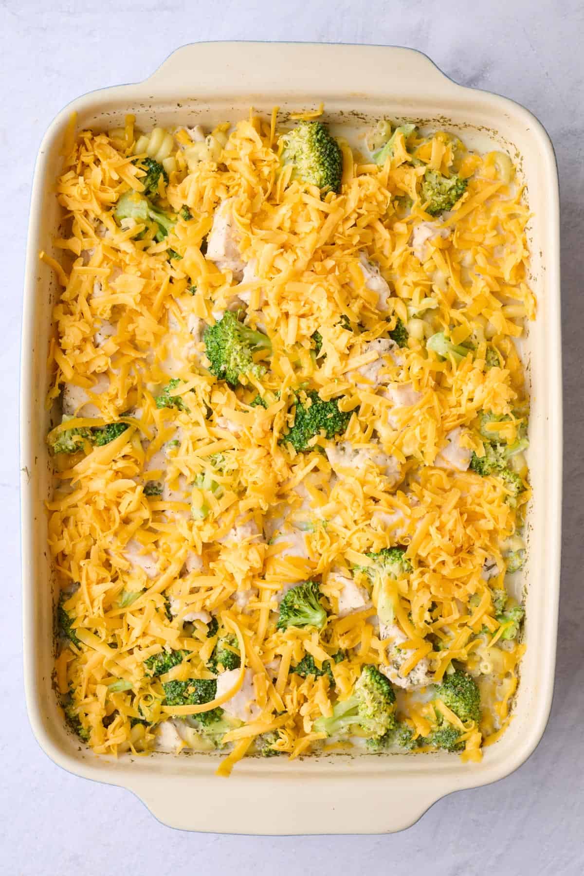 Shredded cheddar cheese on top of recipe before baking.