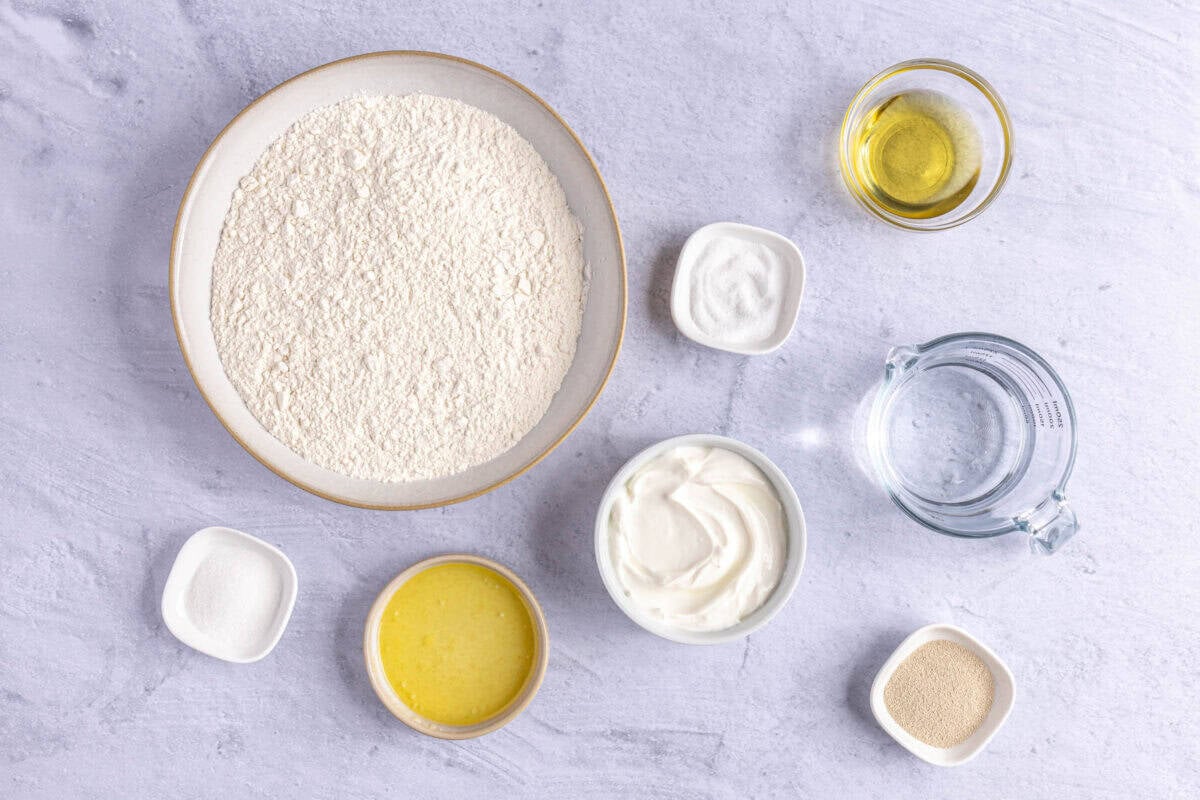 Ingredients for recipe: water, sugar, yeast, yogurt, oil, flour, salt and melted butter.