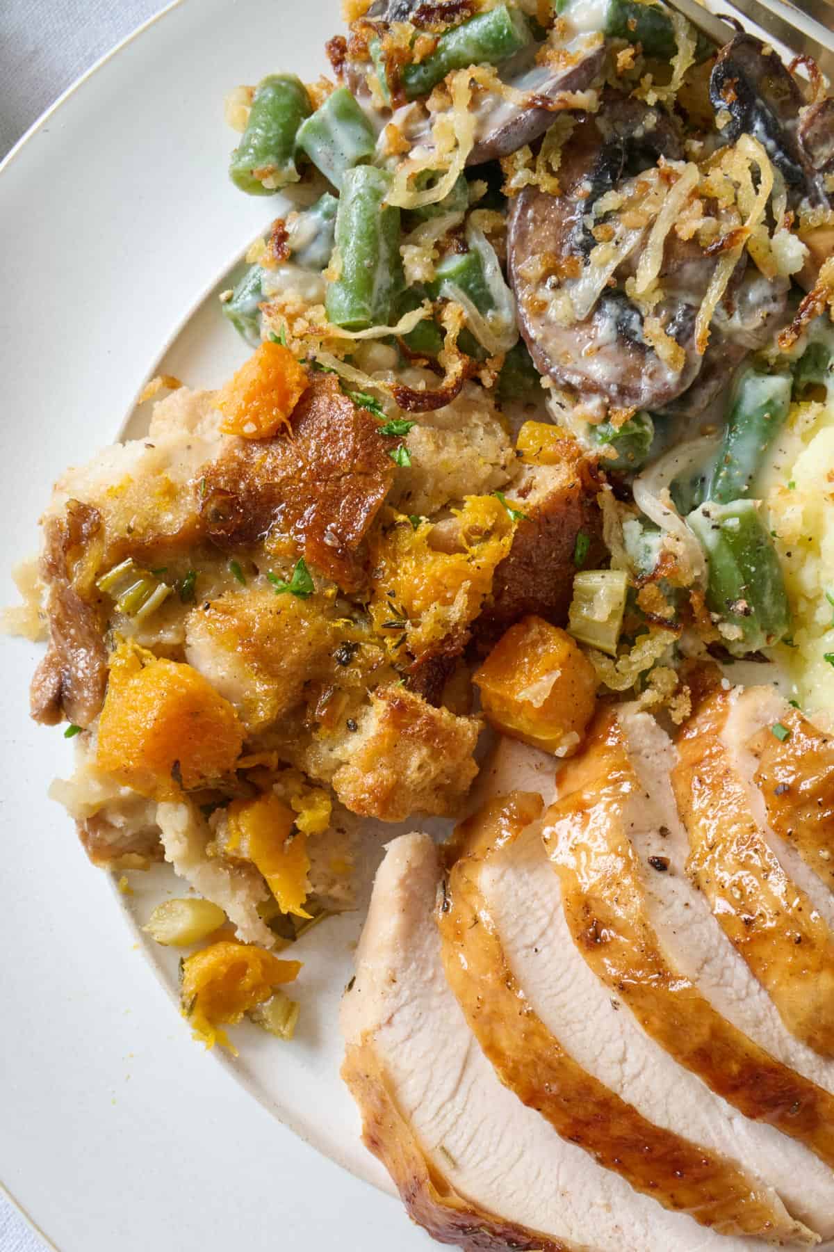 Serving of butternut squash stuffing on Thanksgiving dinner plate.