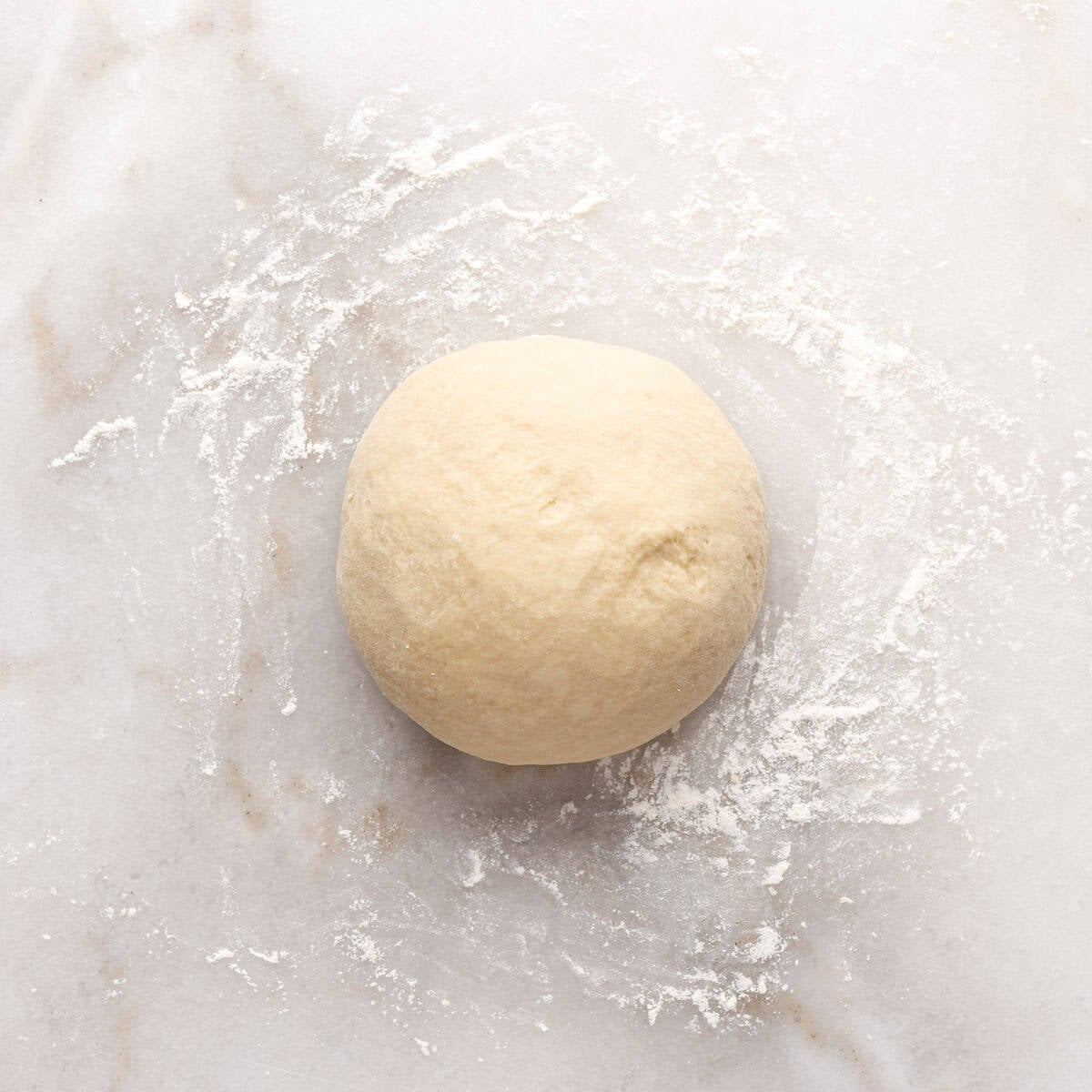 Roll dough on a lightly floured surface and kneading in a soft dough ball.