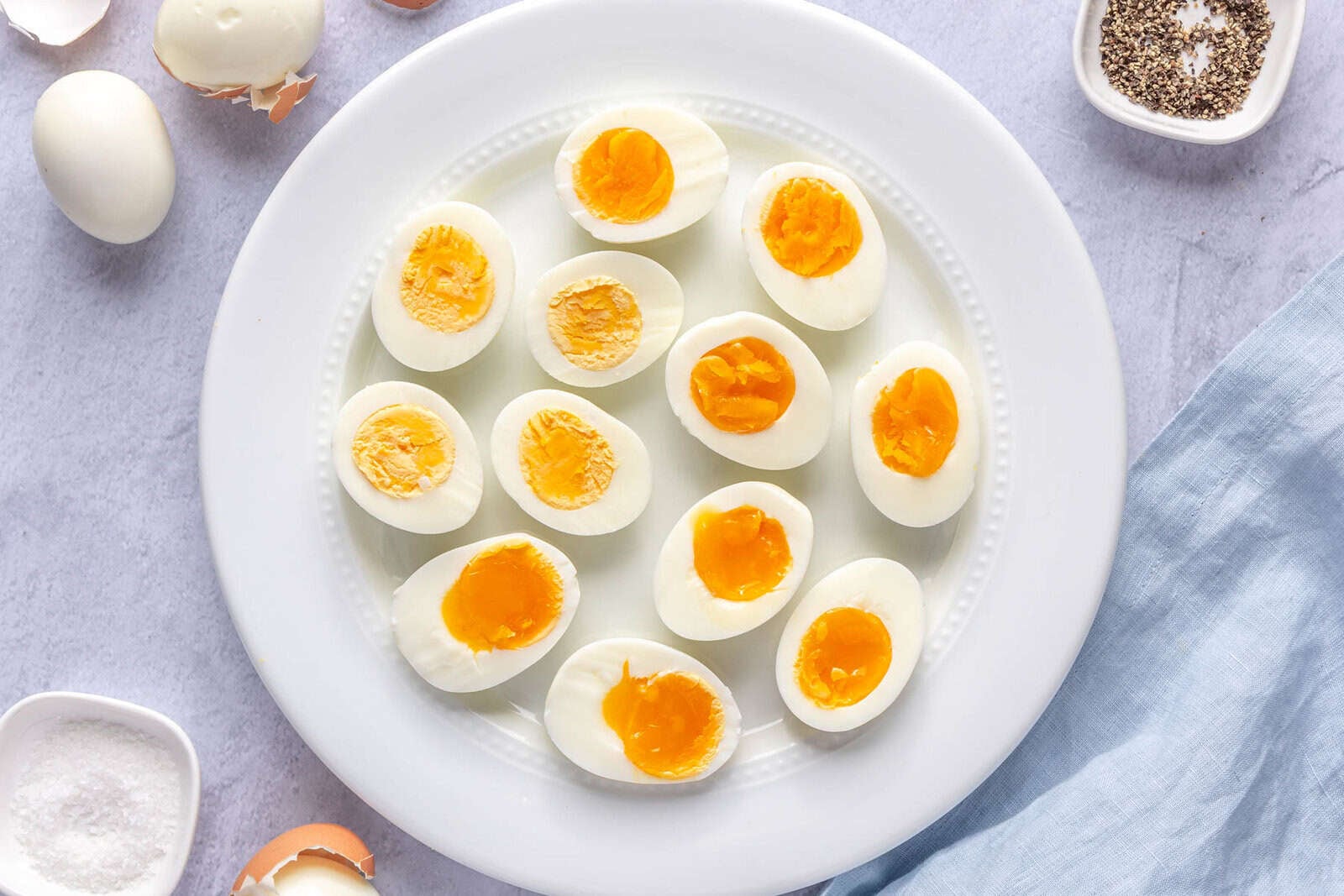 Hard boiled eggs on a plate after cutting in half at varying cook temps.
