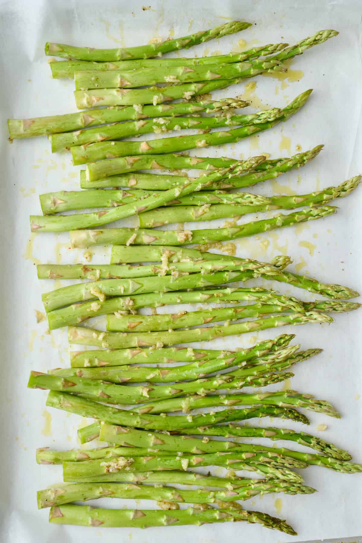 Trimmed asparagus spears tossed with oil, minced garlic, salt and pepper.